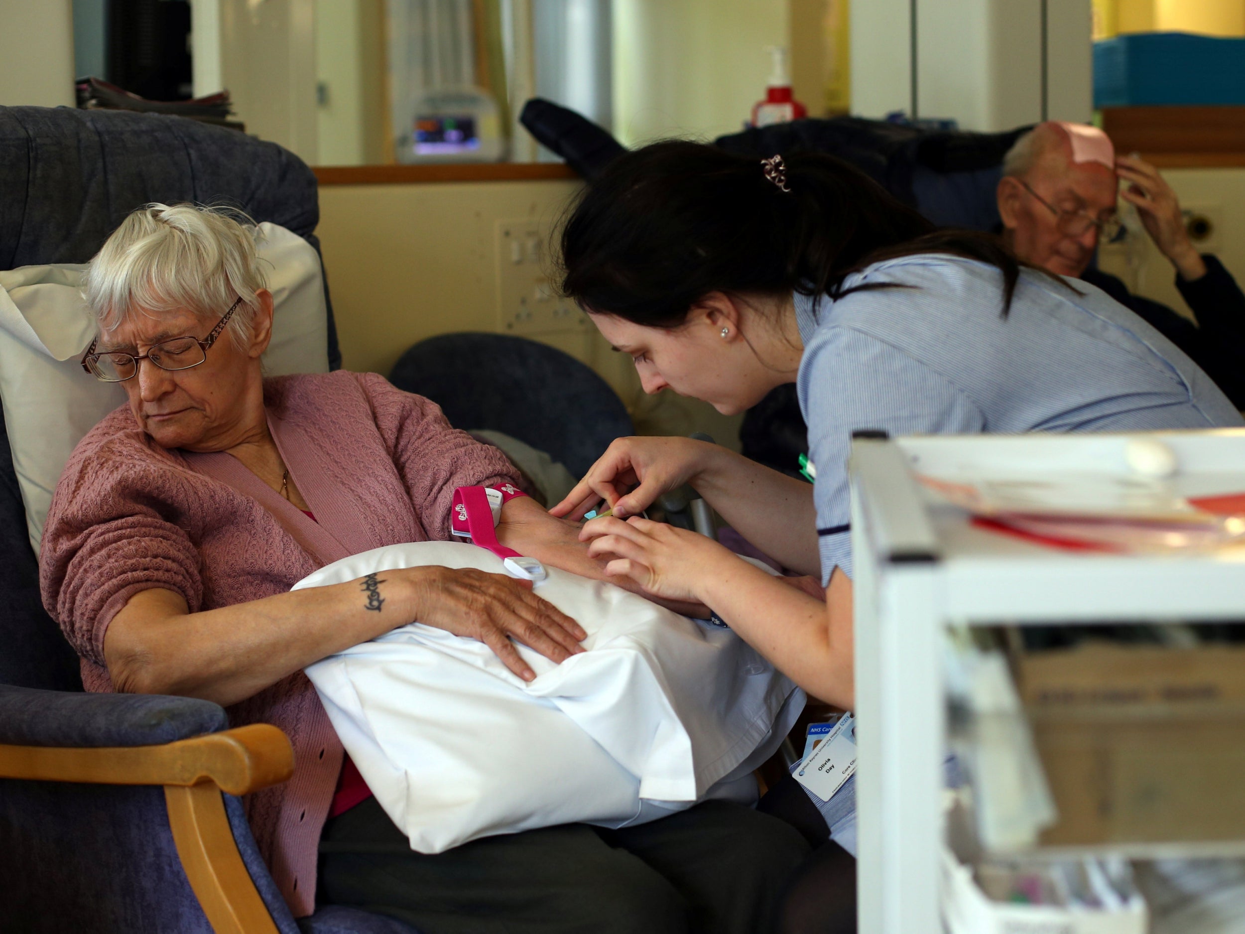 A nurse takes blood from a patient (Reuters)