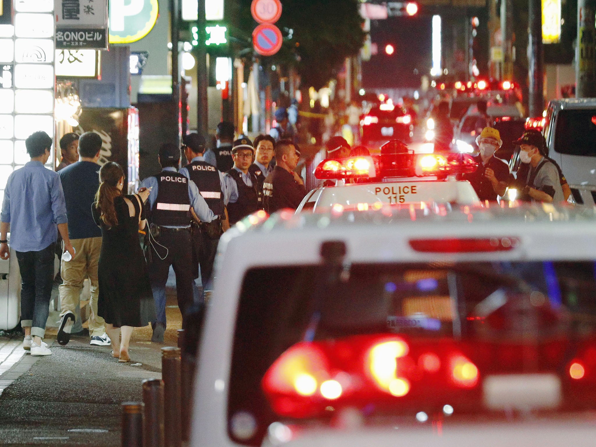 Police officers investigate in Japan city of Fukuoka, where Kenichiro Okamoto, a lecturer at an information technology seminar was stabbed to death