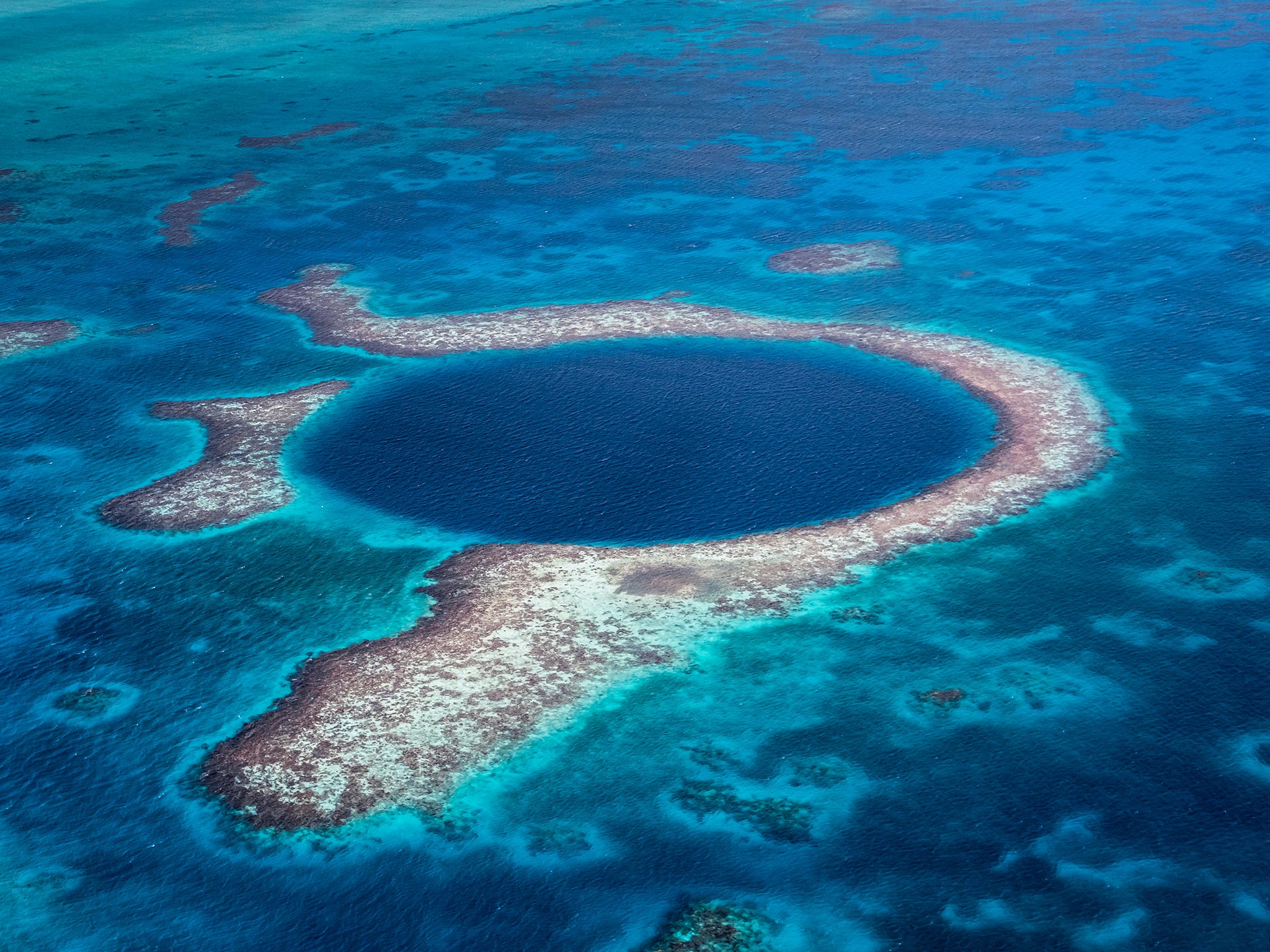 The Belize Barrier Reef system extends roughly 200 miles along the eastern coast of the Yucatan Peninsula