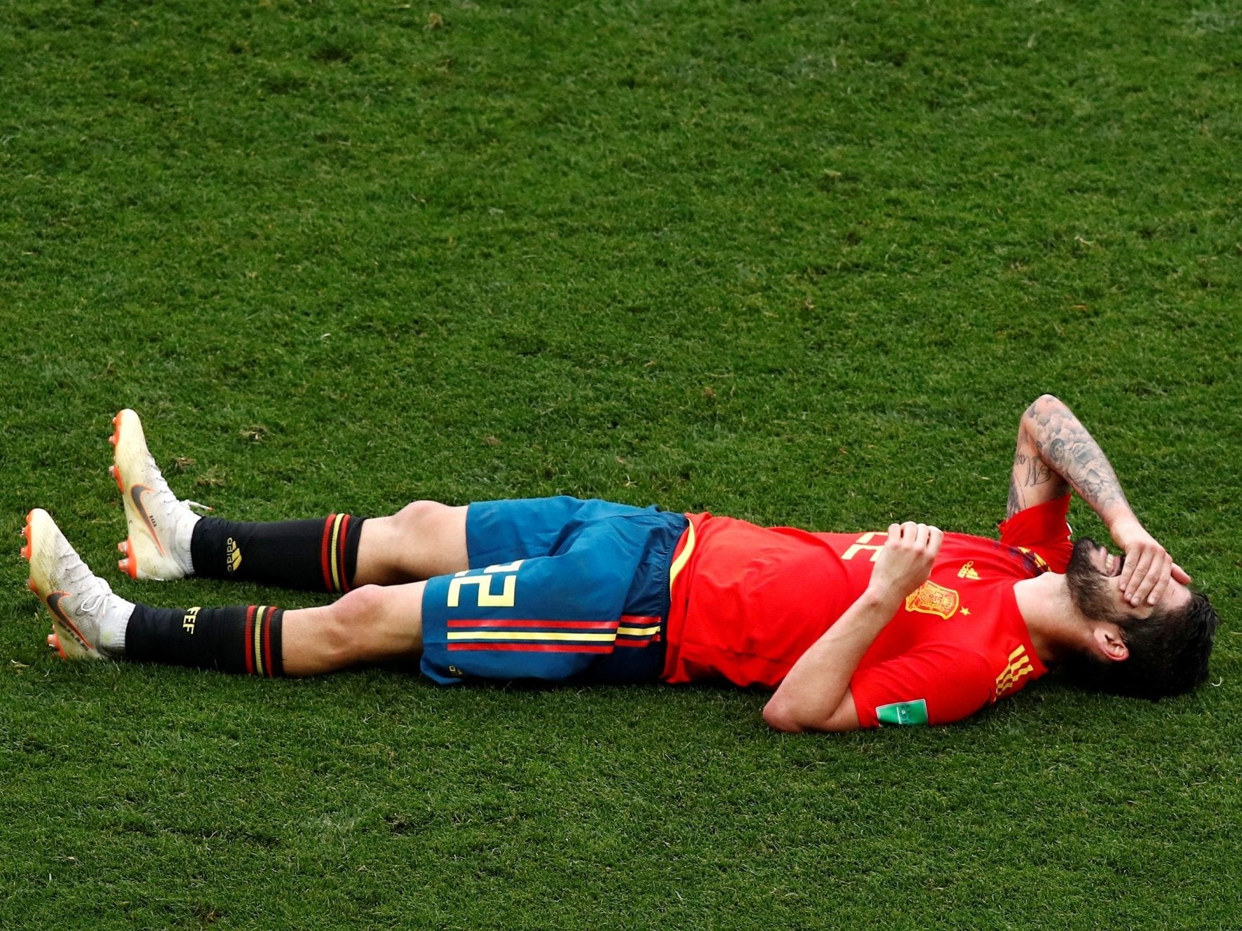 Down and out: Isco reacts to Spain's World Cup defeat by Russia