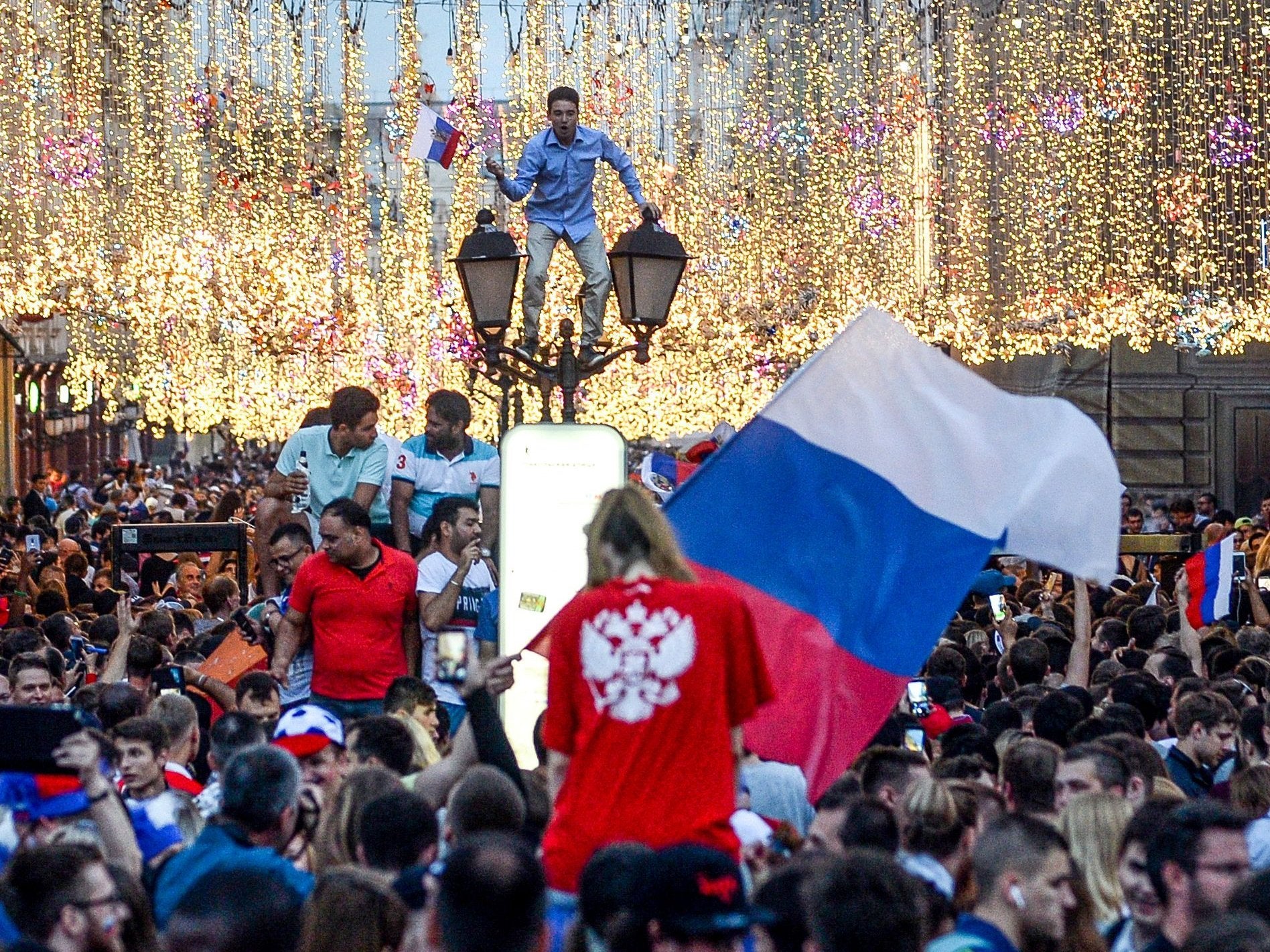 Fans celebrate in Moscow after the host nation sent Spain out of the World Cup