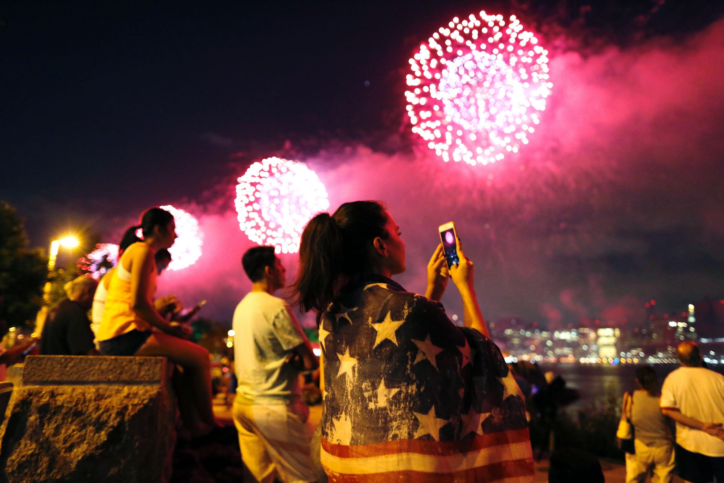 People watch a fireworks show in Queens, New York