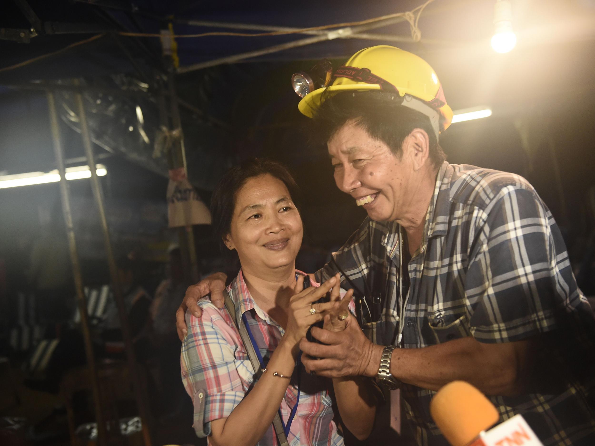 Family members of one of the missing boys celebrate while camping out near Than Luang cave following news all members of children’s football team and their coach were alive in the cave at Khun Nam Nang Non Forest Park in the Mae Sai district of Chiang Rai province (AFP PHOTO / LILLIAN SUWANRUMPHALILLIAN )