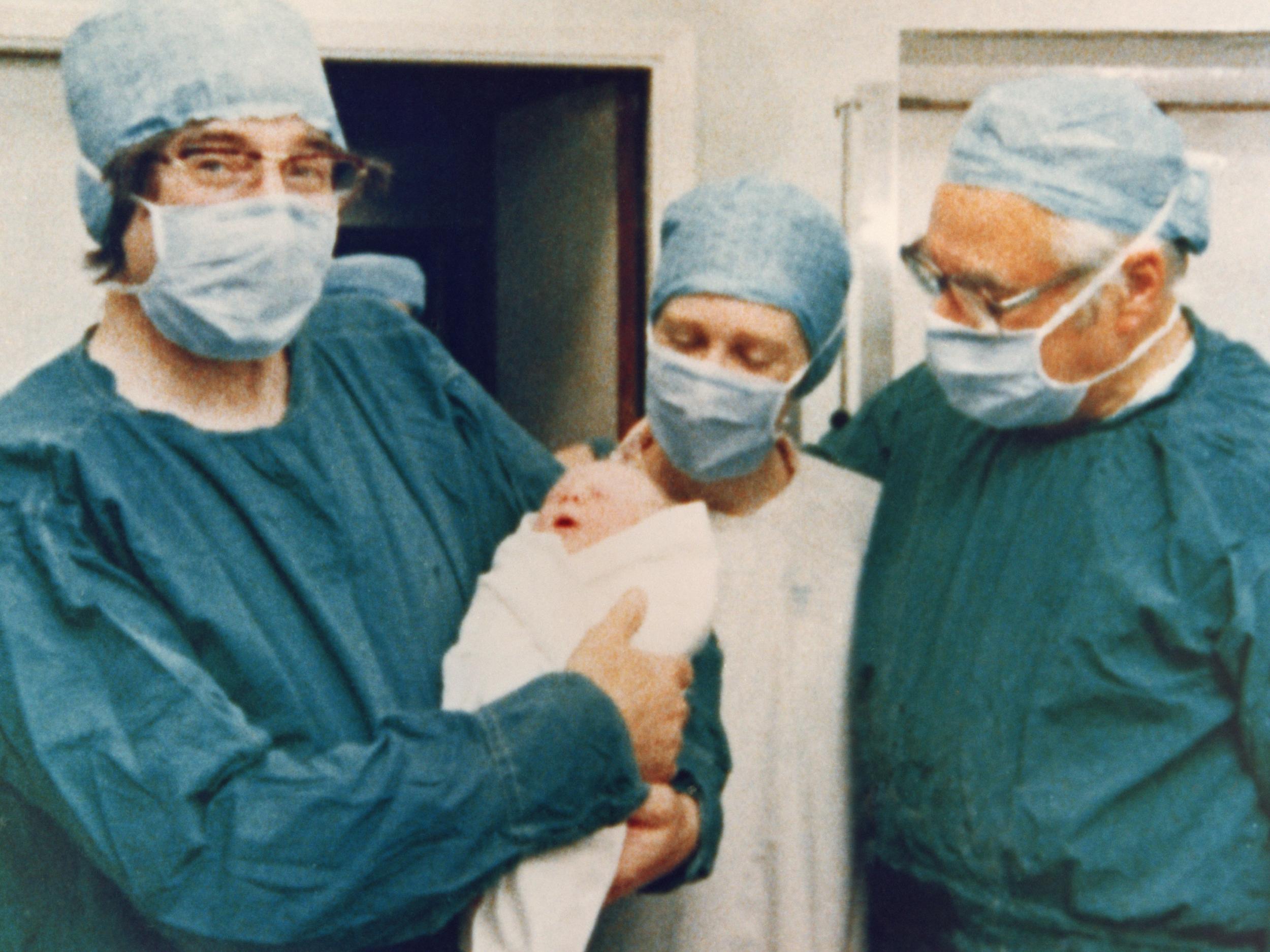 Robert Edwards, holding the world’s first test tube baby, Louise Joy Brown, and Patrick Steptoe (Keystone/Getty)