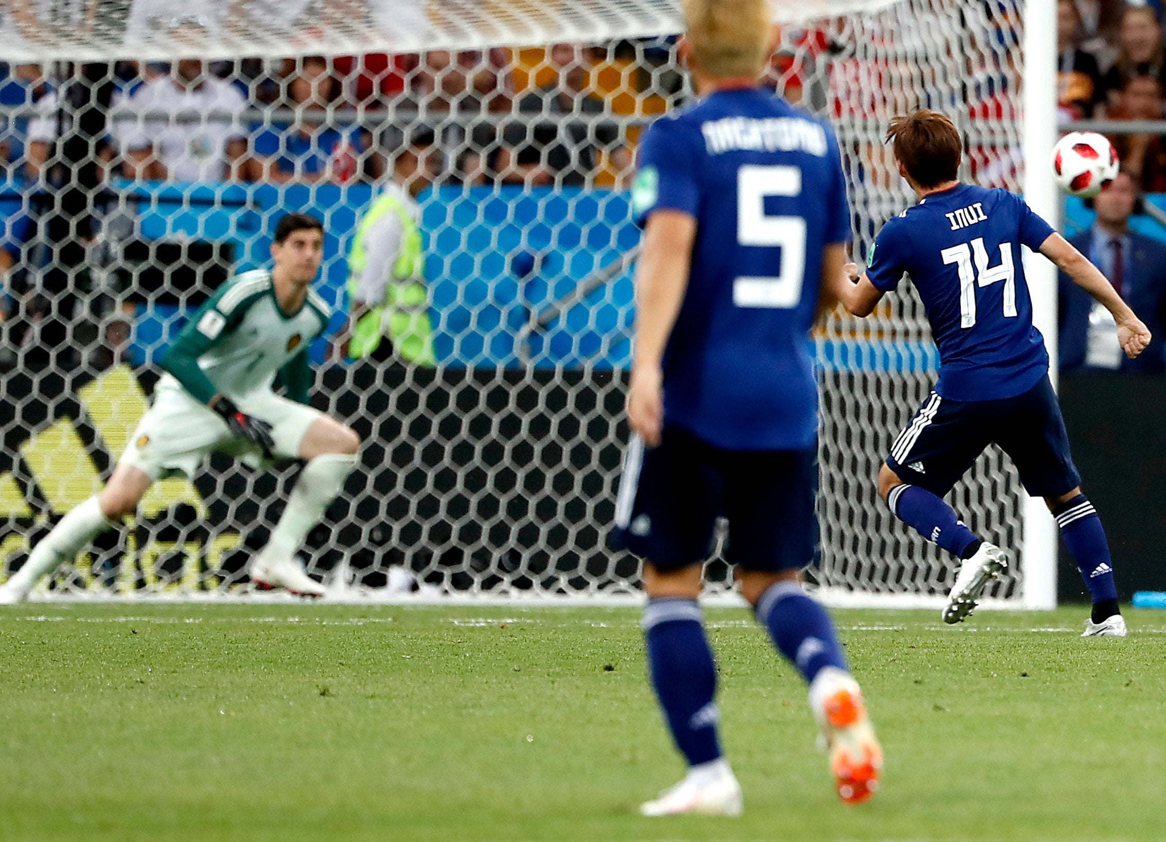 Takashi Inui of Japan (R) scores the 2-0 goal