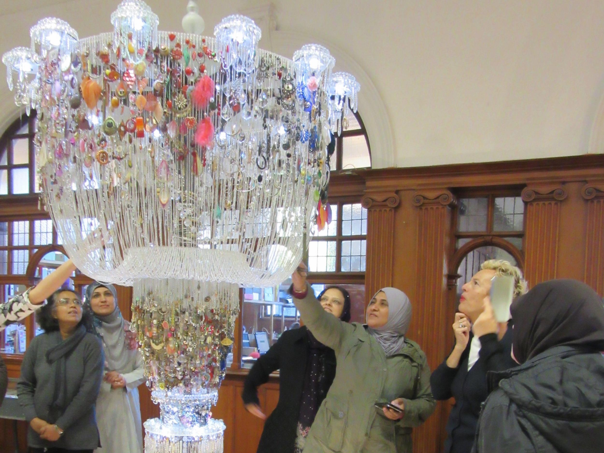 GWL visitors admire 'Chadelier of Lost Earrings', by Lauren Sagar and Sharon Campbell