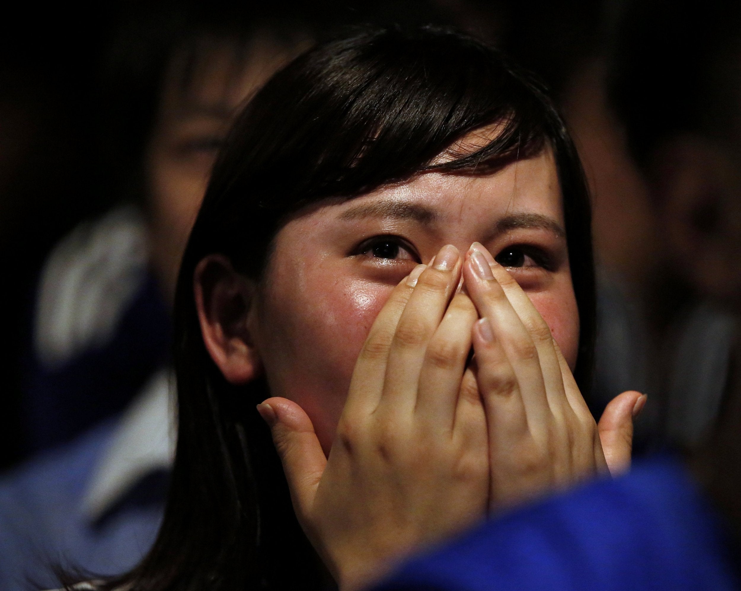 Japanese fan Nao Okada cries after Japan suffered defeat by Belgium