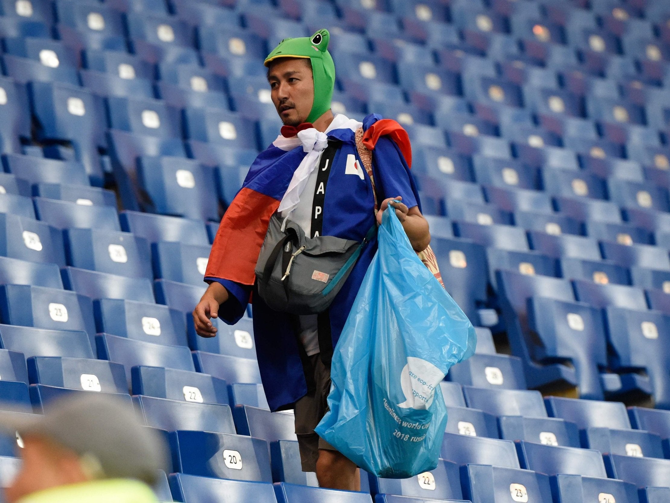 Japan fans clean up the Rostov Arena stadium after the defeat by Belgium