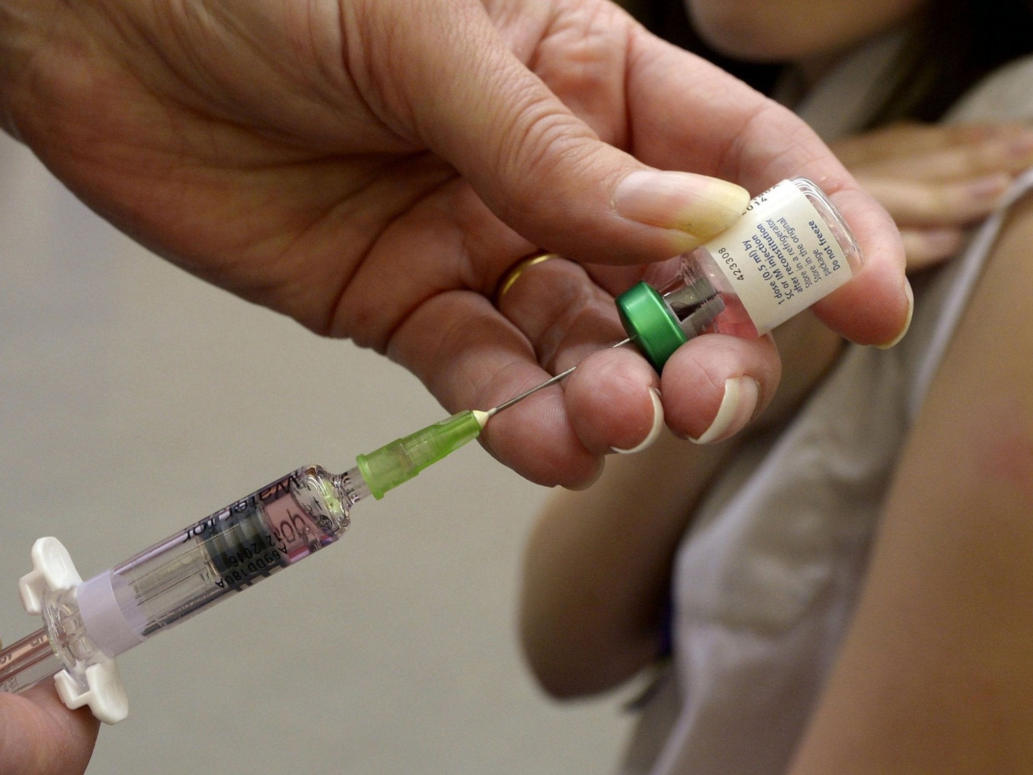 A health worker administering a measles vaccination