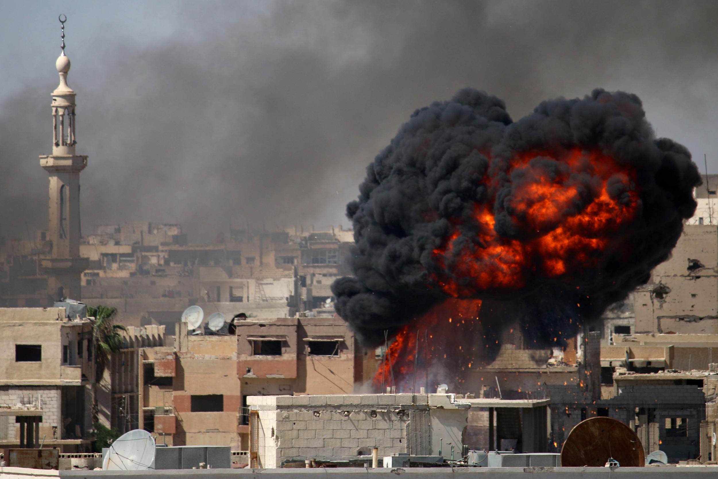 A ball of fire rises from a building following a reported airstrike by Syrian government forces on a rebel-held area in the southern city of Daraa on 11 June, 2018