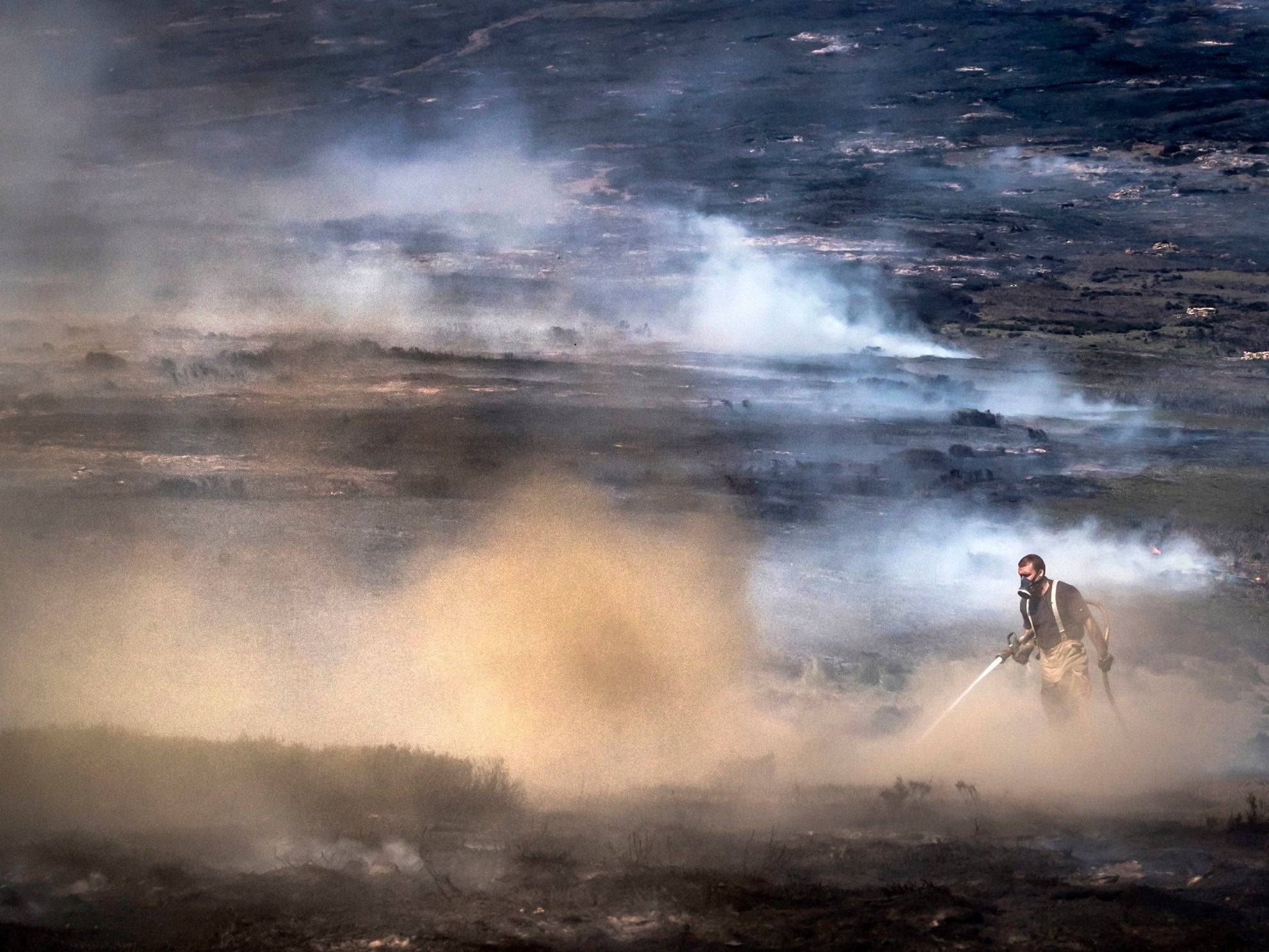 Firefighters tackle the wildfire on Saddleworth Moor