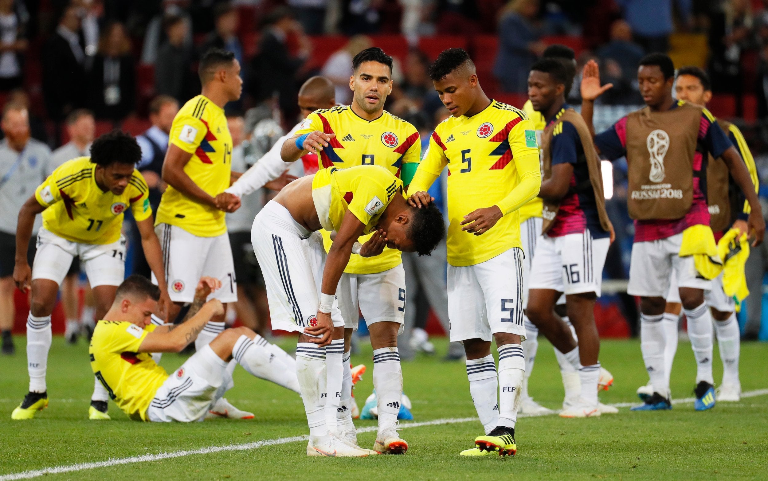 Colombia players react after losing a penalty shootout against England