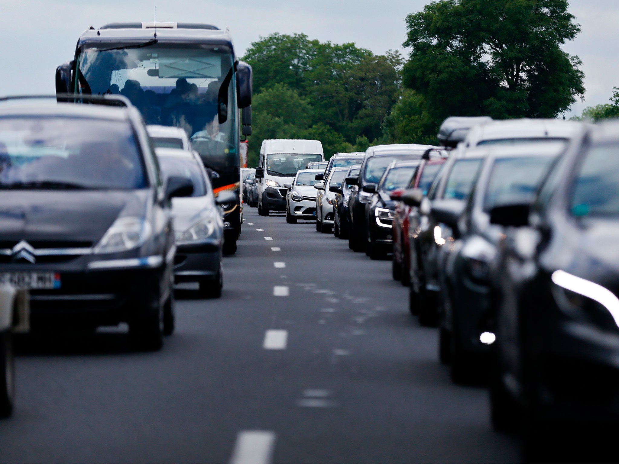 Motorists wait on the A13 highway during a traffic jam near the French town of Annebault