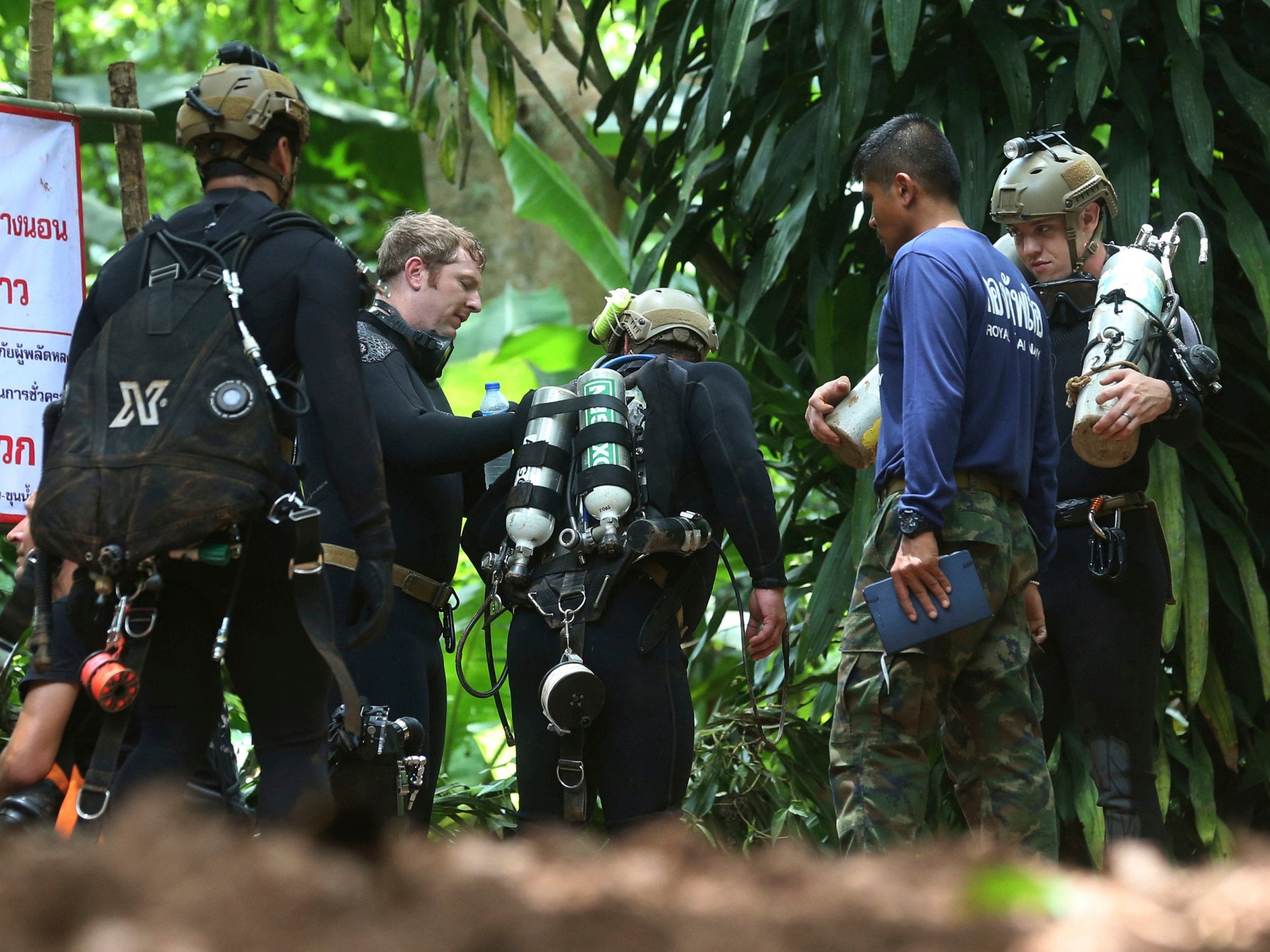 International rescuers prepare to enter the cave where a young soccer team and their coach are trapped by flood waters