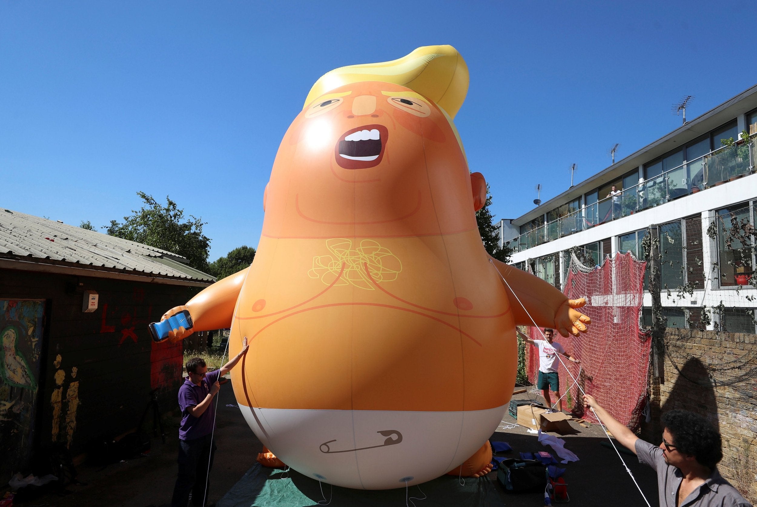 People inflated a helium-filled Donald Trump blimp during his visit to London