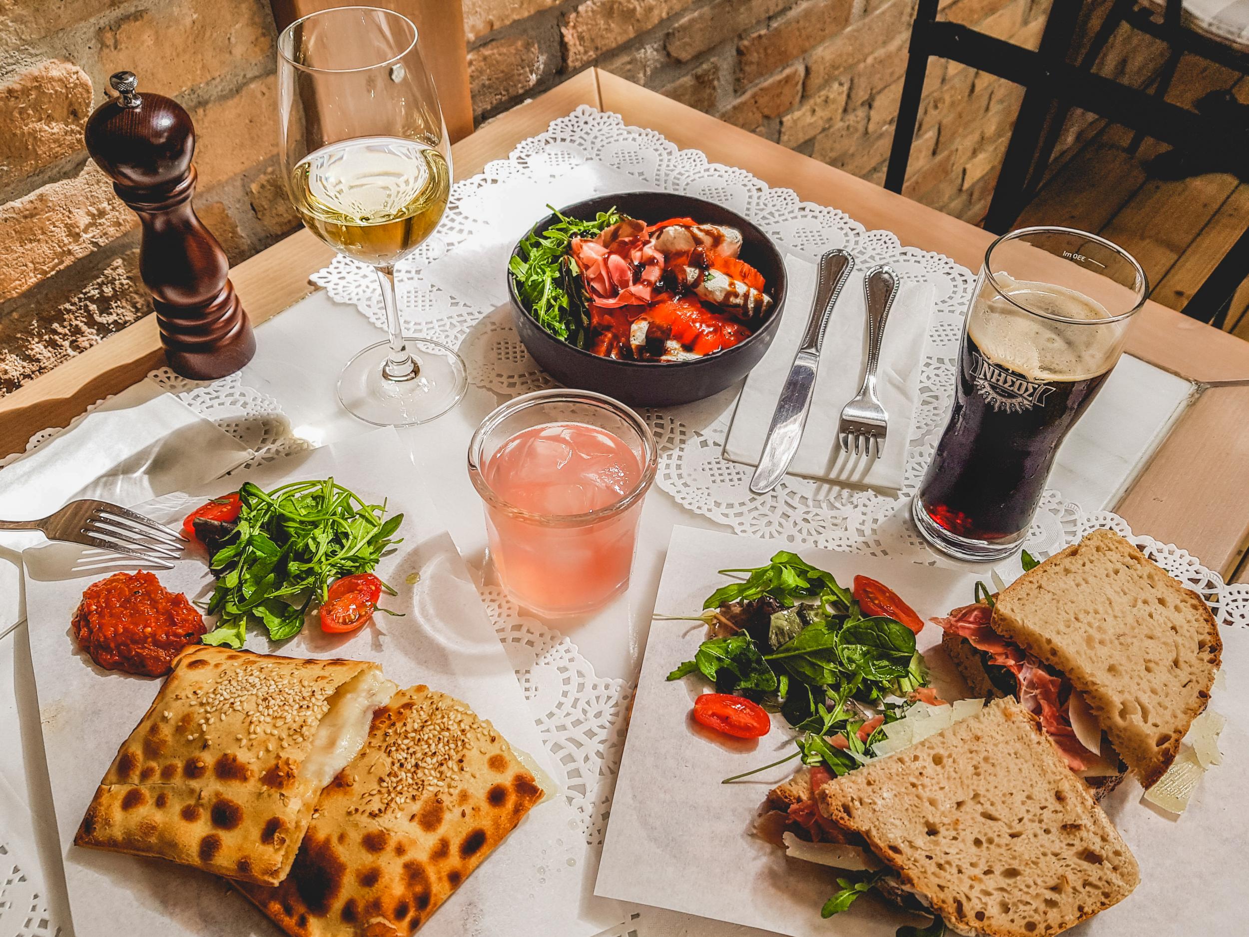 A spread at Yoleni’s in Athens: Cheese pita from Thrace, a Greek prosciutto and Graviera cheese sandwich, and a Greek caprese salad