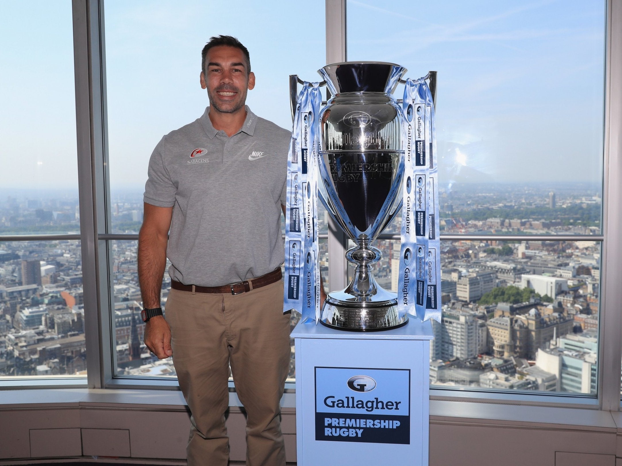 Saracens coach Alex Sanderson poses with the Gallagher Premiership trophy