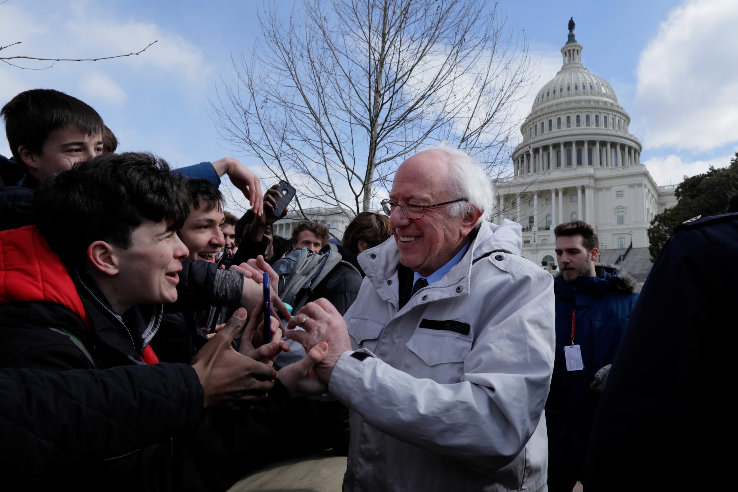 Senator Bernie Sanders (I-VT) greets students gathering outside the U.S. Capitol as part of a nationwide walk-out of classes to demand stricter gun laws in Washington.