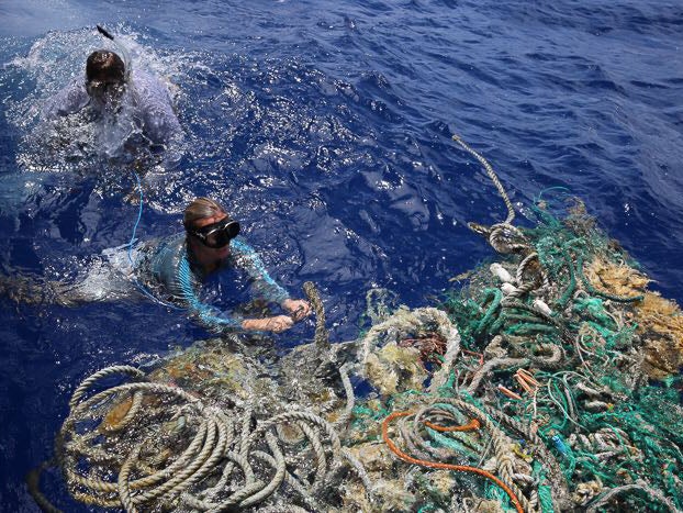 The crew has come across all sorts of marine plastics including fishing nets and household items. Here they fix a tracker to a large pile of marine debris so researchers can track it and better understand ocean currents