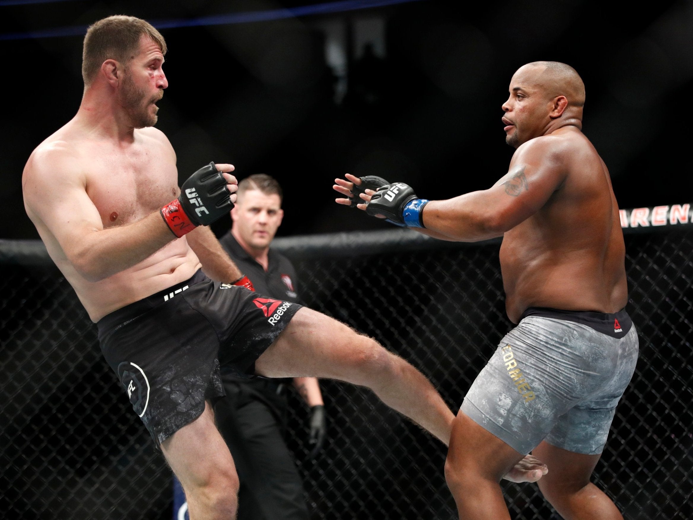 Stipe Miocic kicks Daniel Cormier during their UFC 226 bout