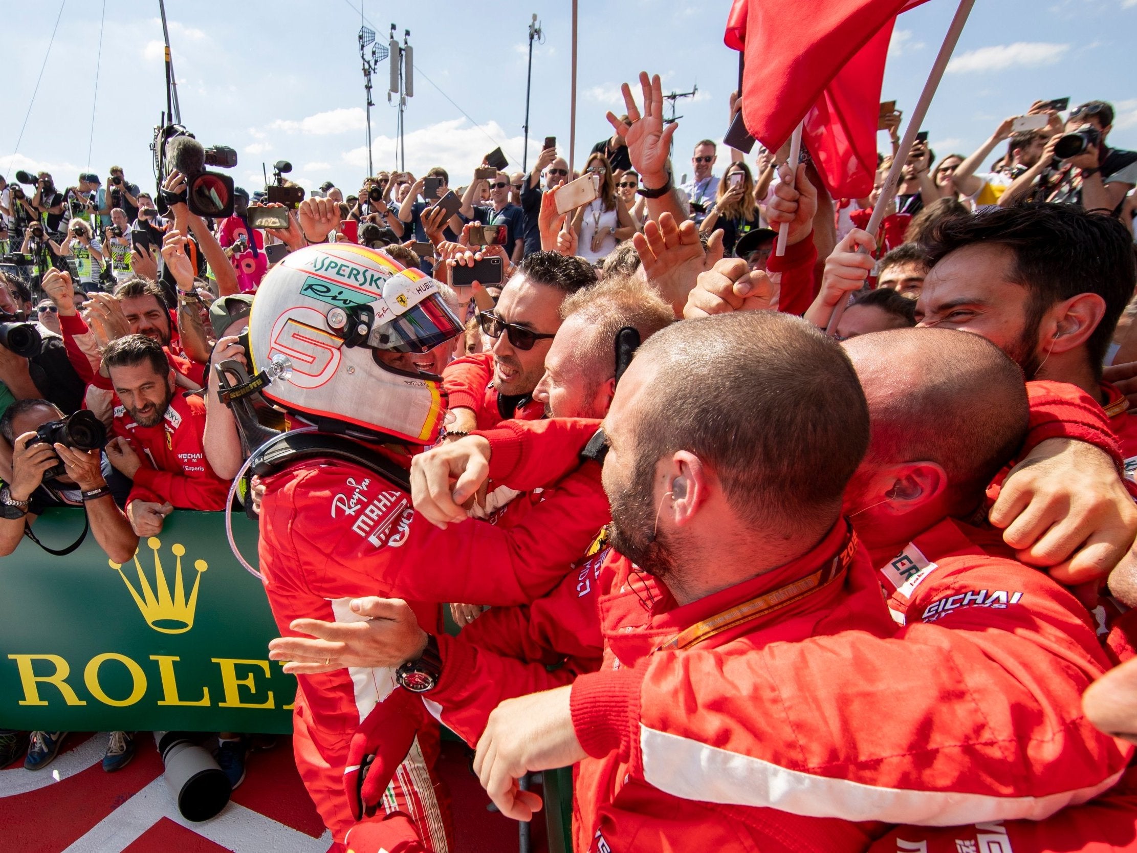 Sebastian Vettel celebrates with his Ferrari team after winning at Silverstone