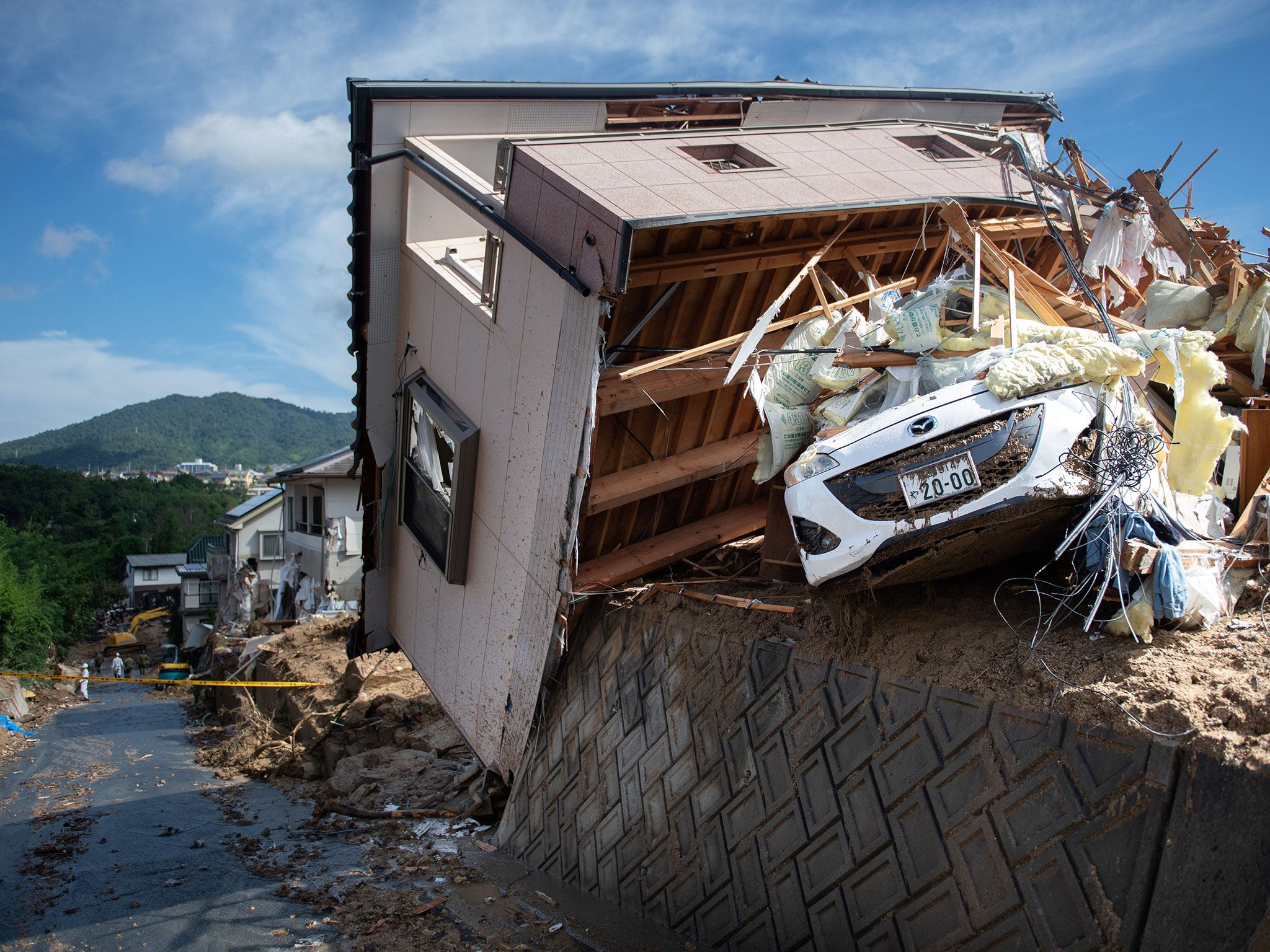 Some homes have been smashed while others were left tilting precariously (AFP/Getty)