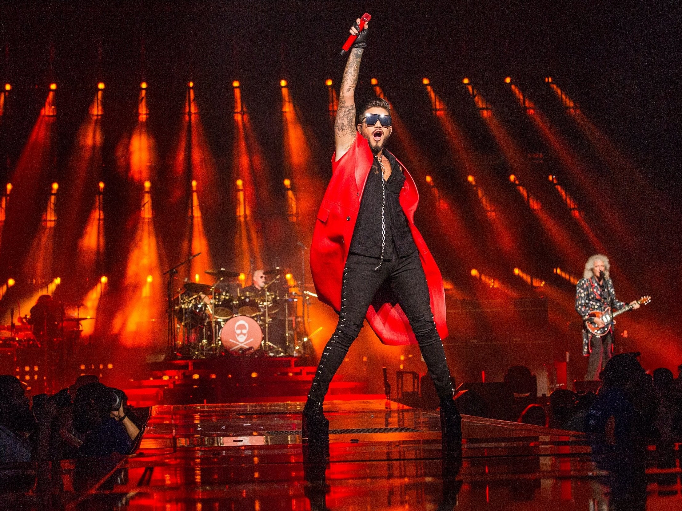 Adam Lambert (centre) performs with Brian May (right) and Roger Taylor (left) at The O2 Arena