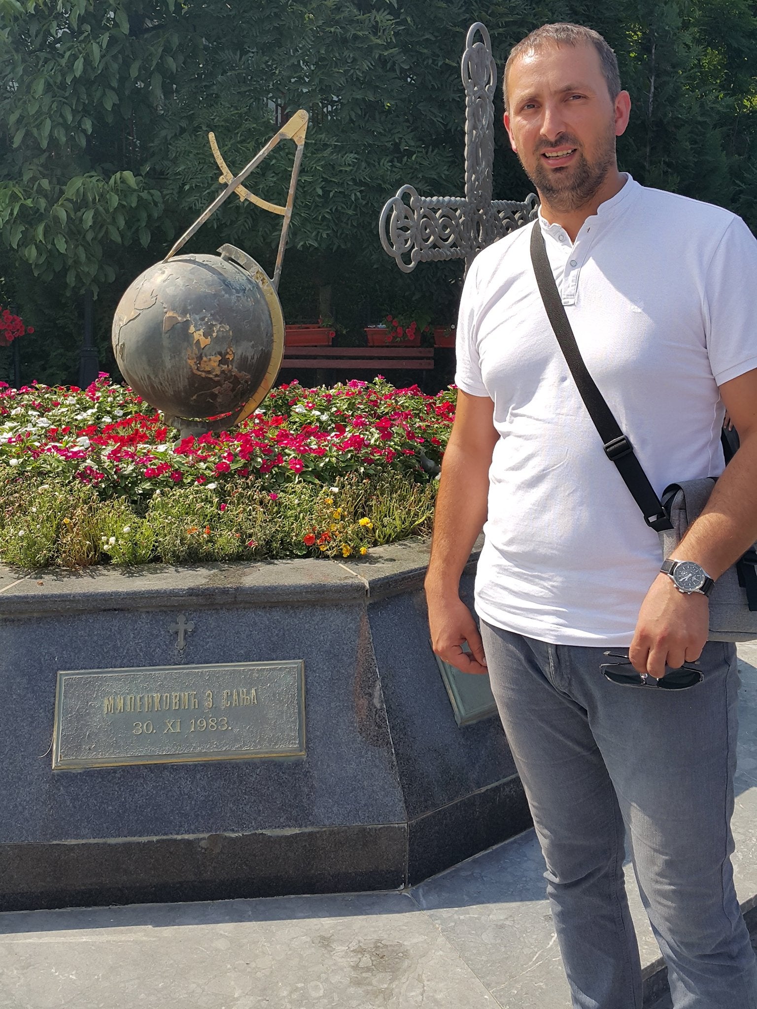 Sasha Milenkovic stands next to a memorial to the 10 civilians killed by Nato bombs, including his 15-year old sister Sanja, in the Serbian village of Varvarin in 1999