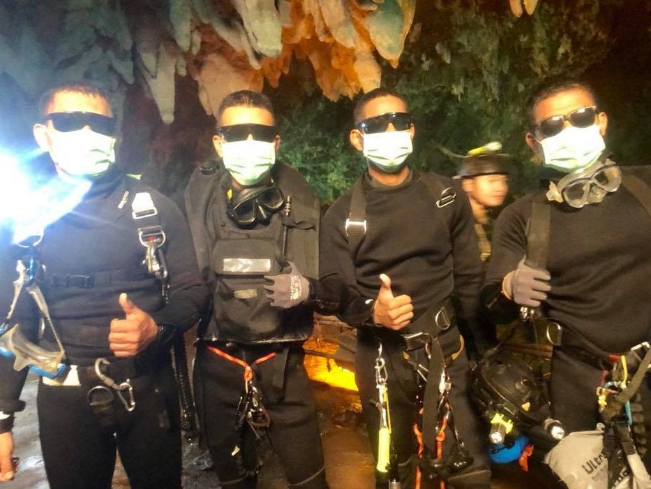 The last four Thai navy Seal divers emerge from the cave on Tuesday night (Thai navy Seal/Getty)