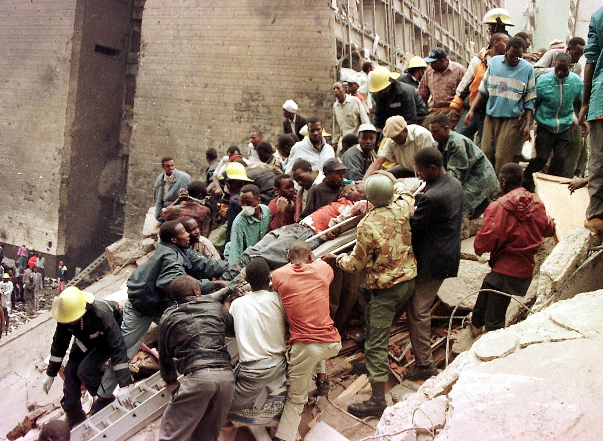 Citizens work to remove the bodies of those who died when a bomb exploded near the US embassy in Nairobi