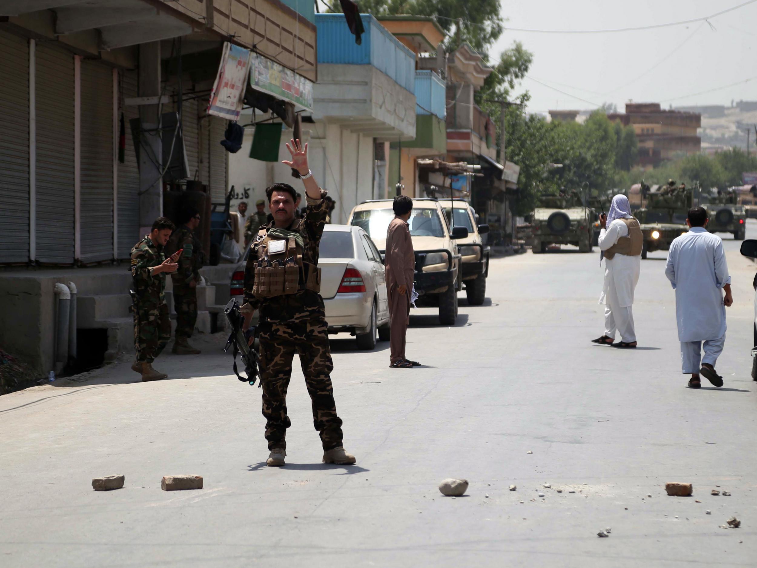 Afghan soldiers secure the scene of the attack