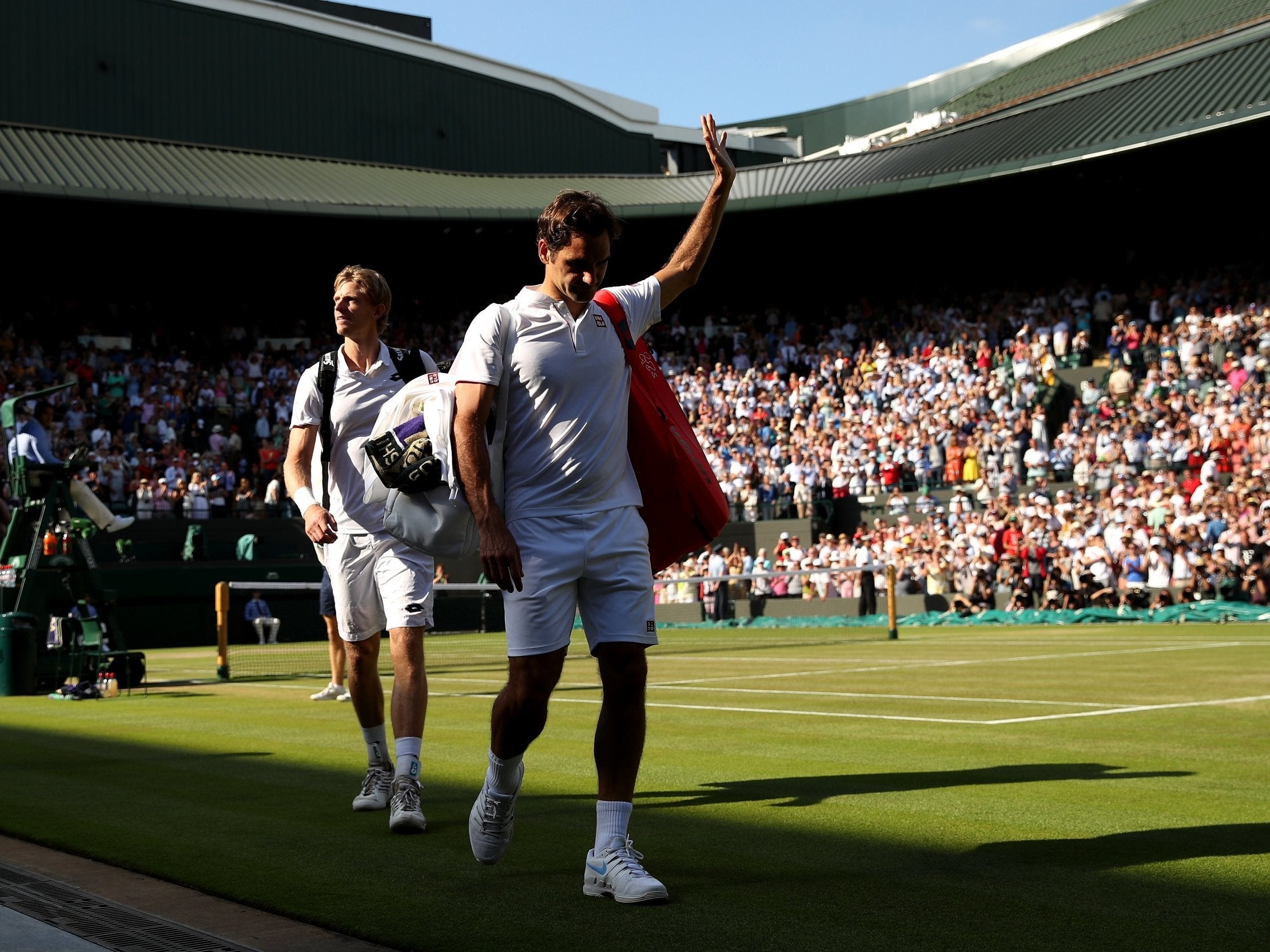 Roger Federer waves goodbye as he leave Court 1 after being knocked out of Wimbledon