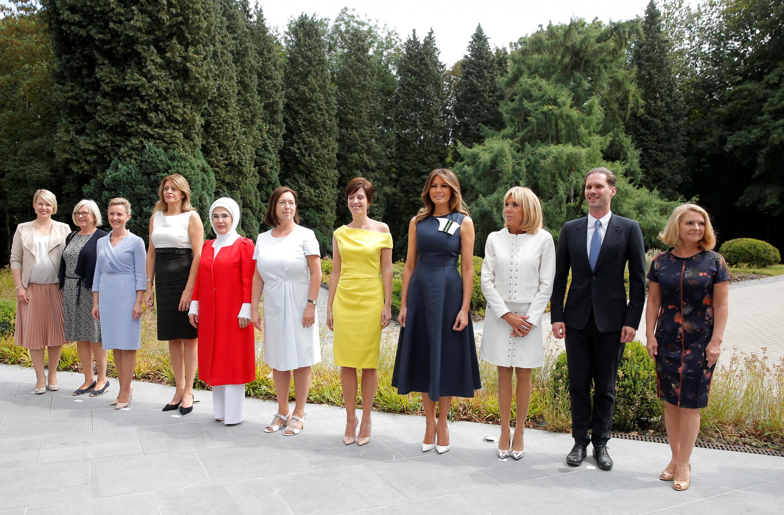 U.S. first lady Melania Trump and France's first lady Brigitte Macron, Sweden Prime Minister's spouse Ulla Lofven, Belgian Prime Minister's partner Amelie Derbaudrenghien, Slovenian Prime Minister Miro Cerar's partner, Mojca Stropnik, Bulgarian President Rumen Radev's partner Desislava Radeva, Turkey's first lady Emine Erdogan, Jens Stoltenberg's spouse Ingrid Schulerud, European Council President Donald Tusk's wife Malgorzata Sochacka, and Luxemburg's Prime Minister Xavier Bettel's husband, Gauthier Destenay, pose for a picture after attending a concert at the Queen Elisabeth Music Chapel in Waterloo, Belgium July 11, 2018.