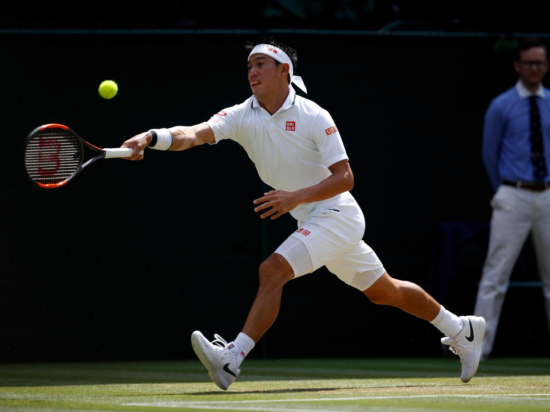 Nishikori reaches to return a forehand shot