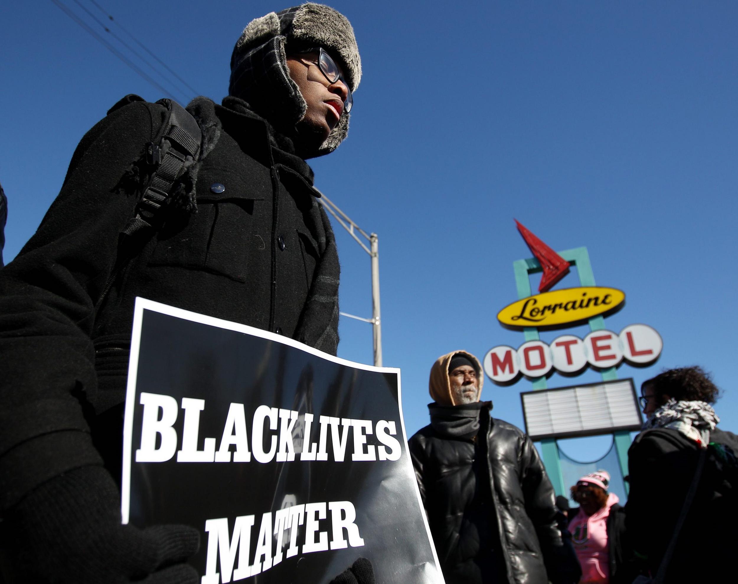 Tariq Thompson holds a Black Lives Matter sign outside the National Civil Rights Museum