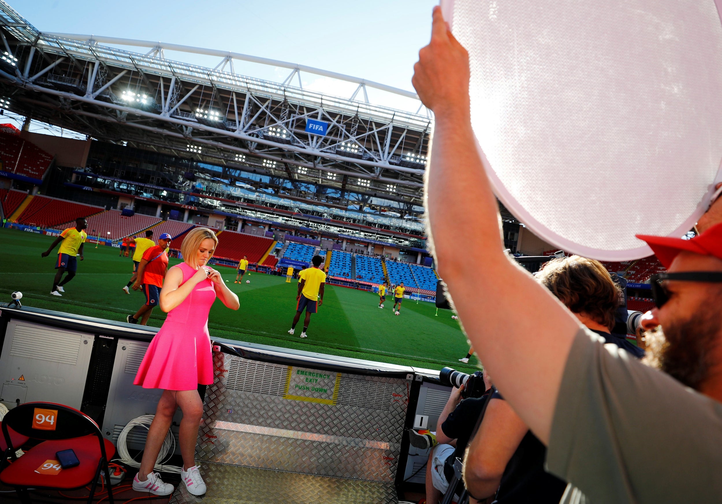 A TV presenter gets ready for her live-take during a training session at the Spartak stadium in Moscow