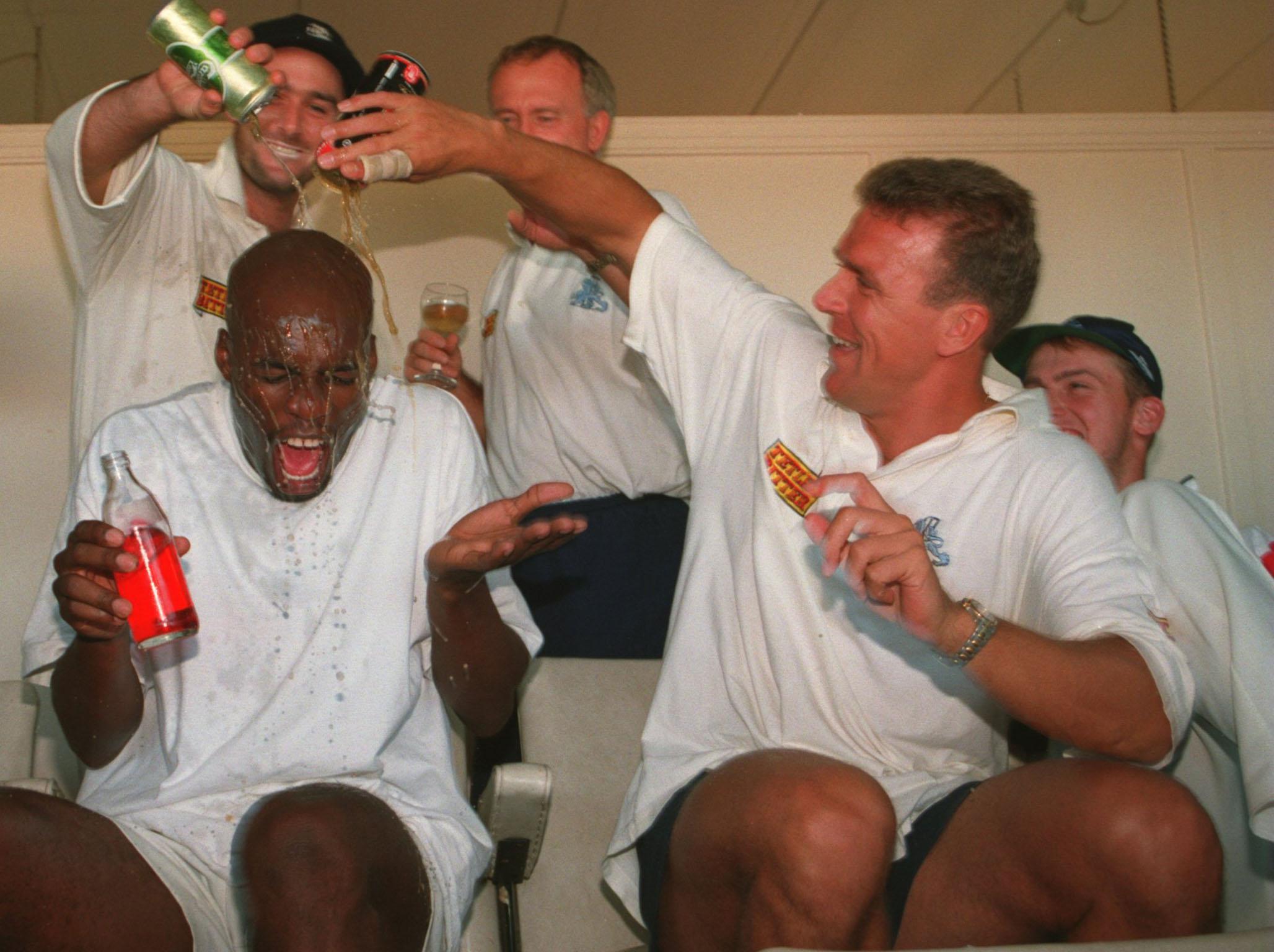 Alec Stewart and Graham Thorpe soak Chris Lewis after winning in Adelaide