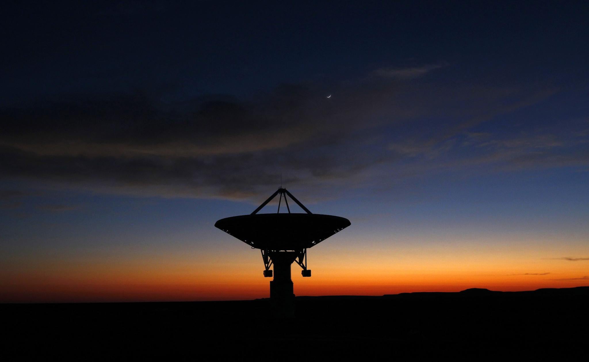 Dawn breaks over a radio telescope dish of the KAT-7 Array pointing skyward at the proposed South African site for the Square Kilometre Array (SKA) telescope near Carnavon in the country's remote Northern Cape province in this picture taken May 18, 2012