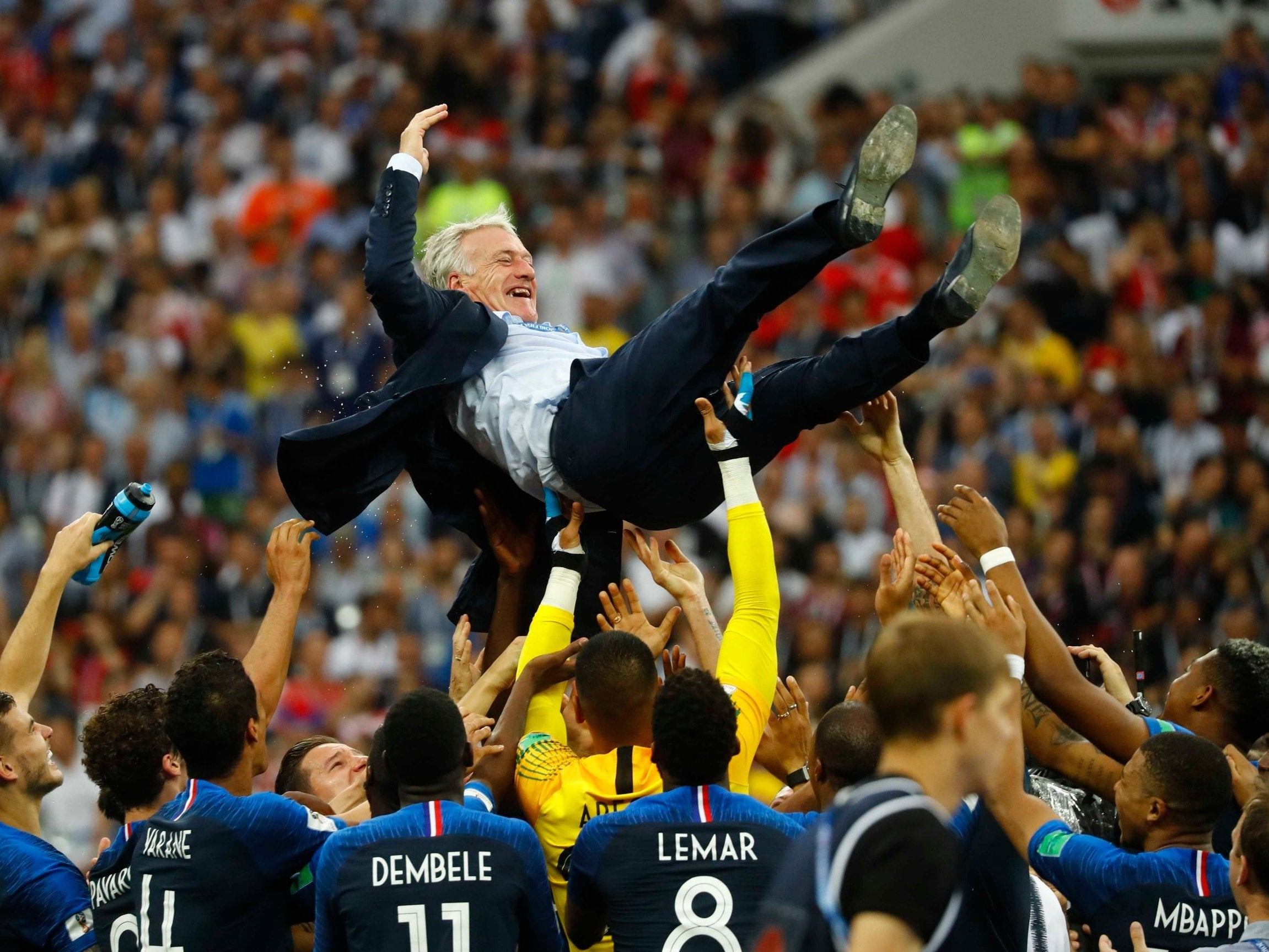 France players celebrate winning the World Cup with coach Didier Deschamps