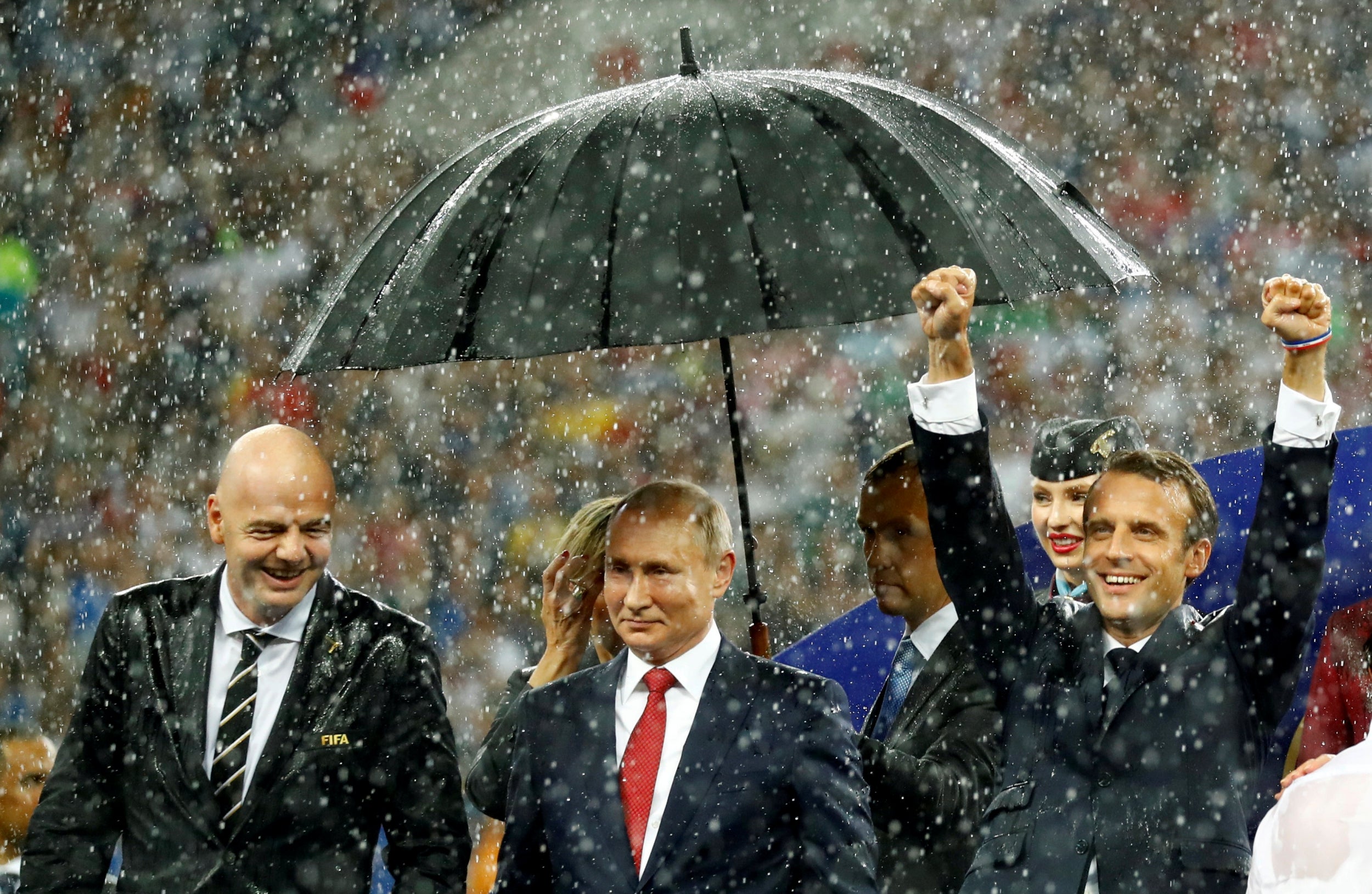 Mr Macron celebrates in the rain (Reuters)