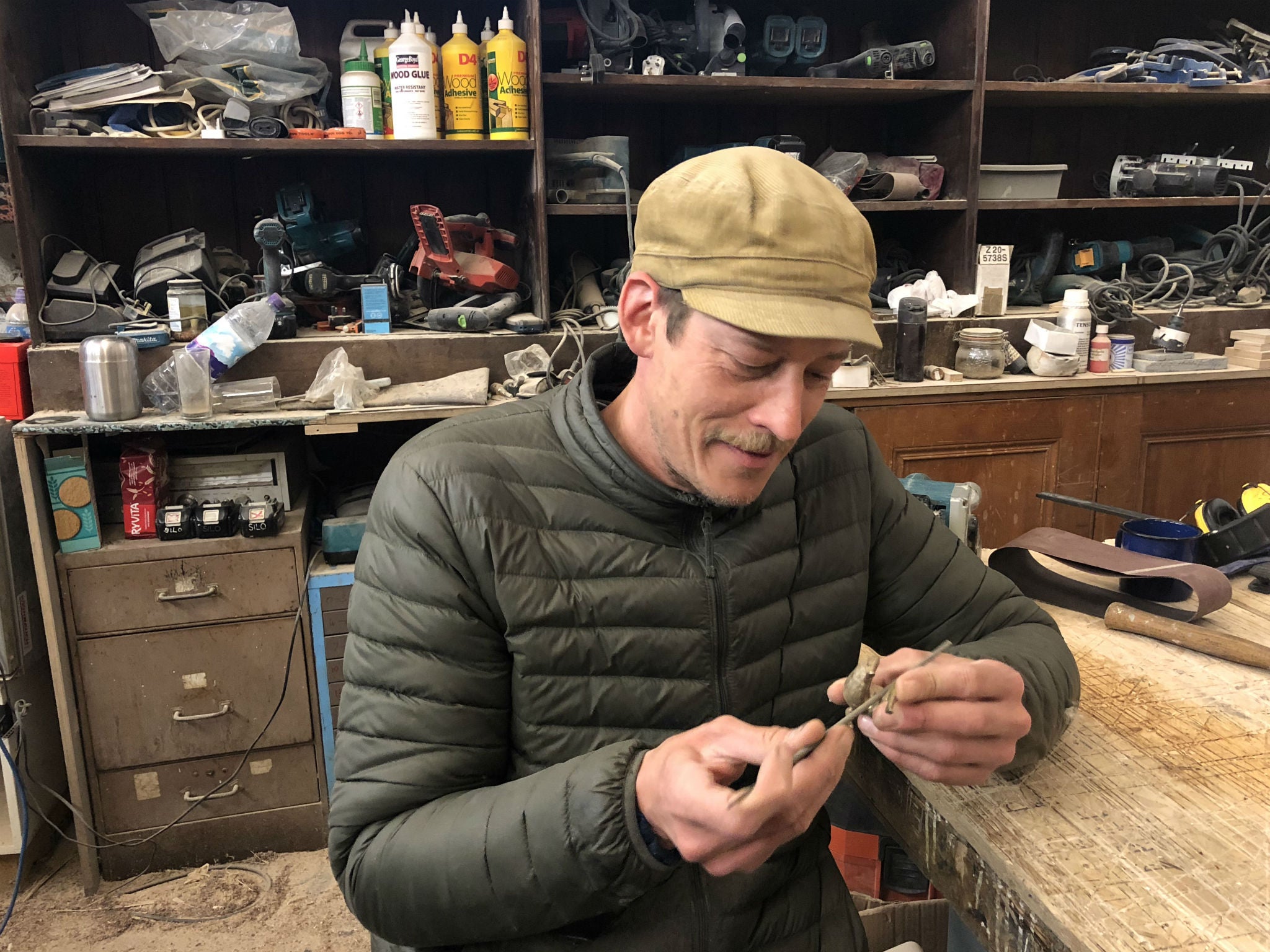 Simon Harlow in the Govanhill workshop he shares with Simon Richardson, with a figurine he made for Lucy Skaer