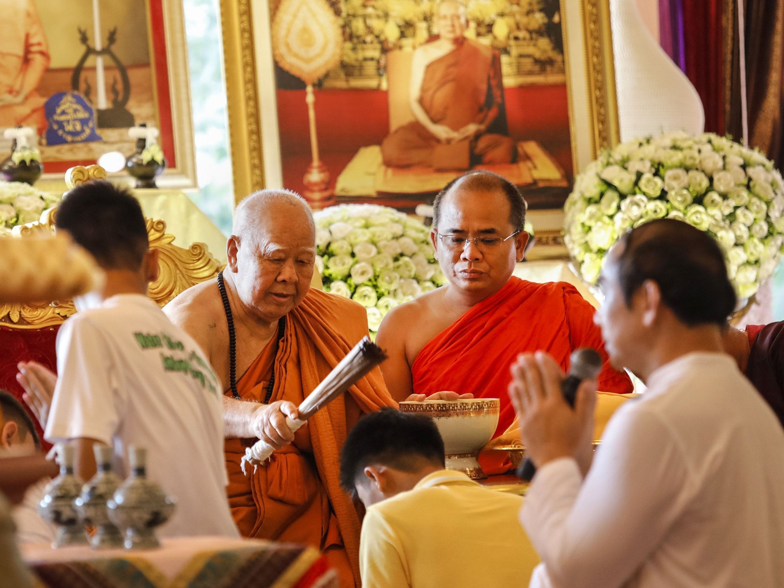 A Buddhist monk blesses some of the 12 Thai boys who were dramatically rescued from deep inside the cave last week