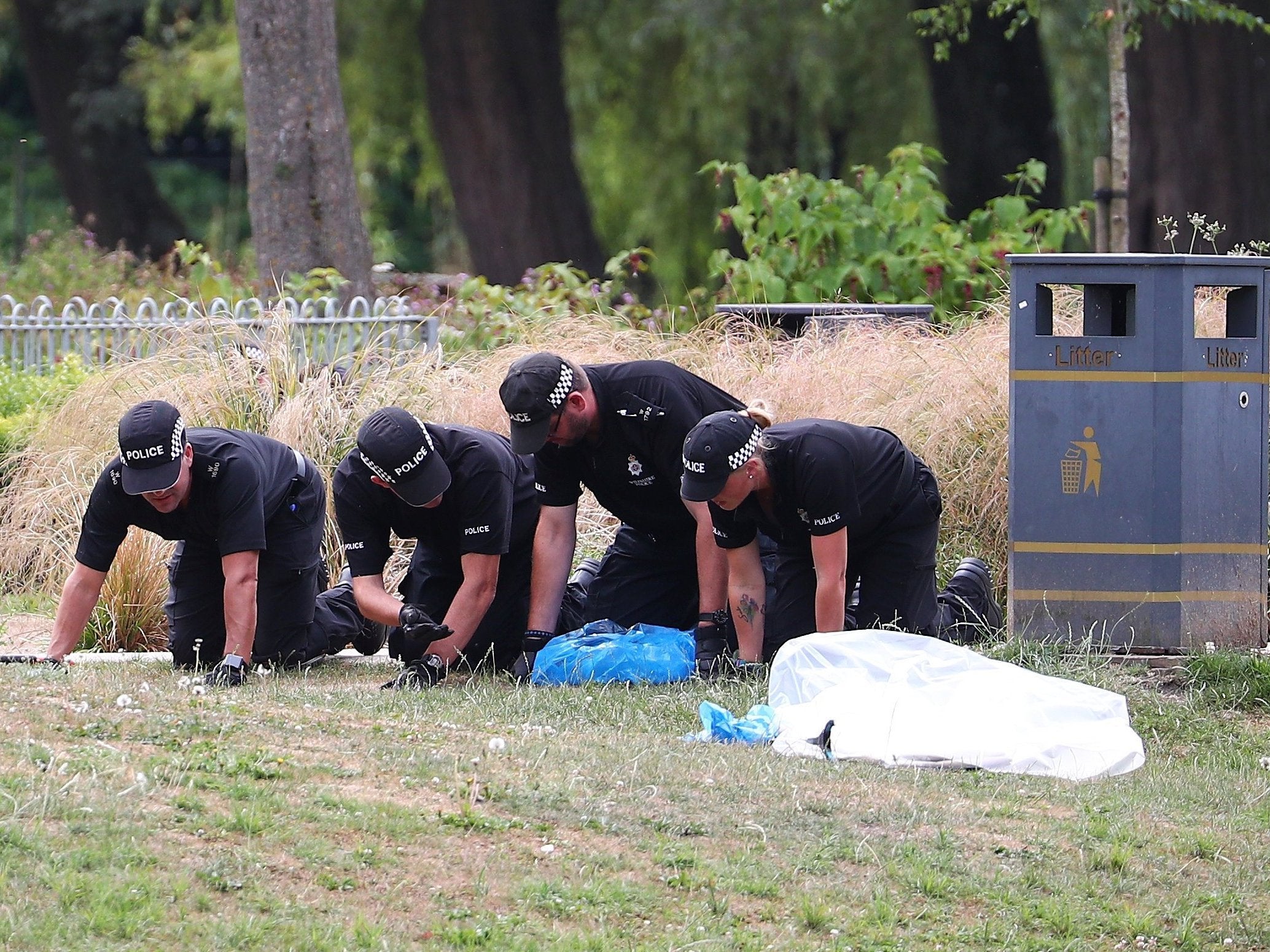 Police officers search Queen Elizabeth Gardens