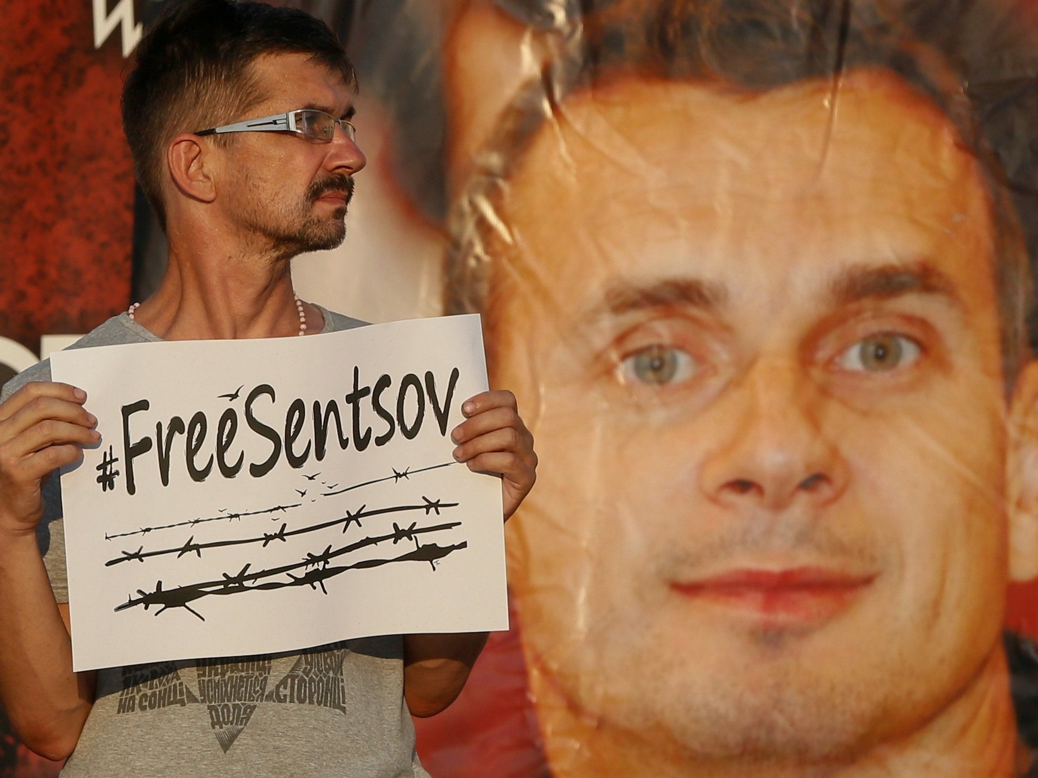 A participant attends a rally demanding the release of film director Oleg Sentsov at the Independence Square in Kiev, Ukraine, 13 July