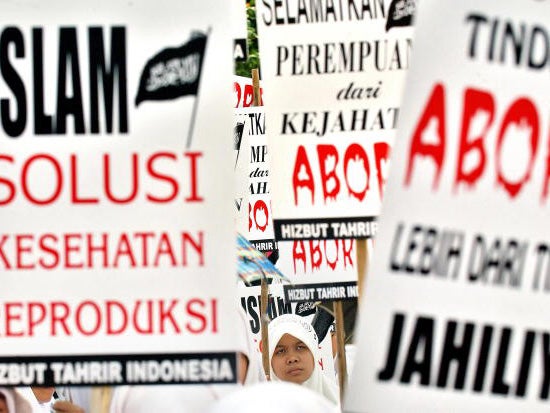 Indonesian women shout slogans during an anti-abortion demonstration in front of the Presidential Palace in Jakarta, 18 September 2005