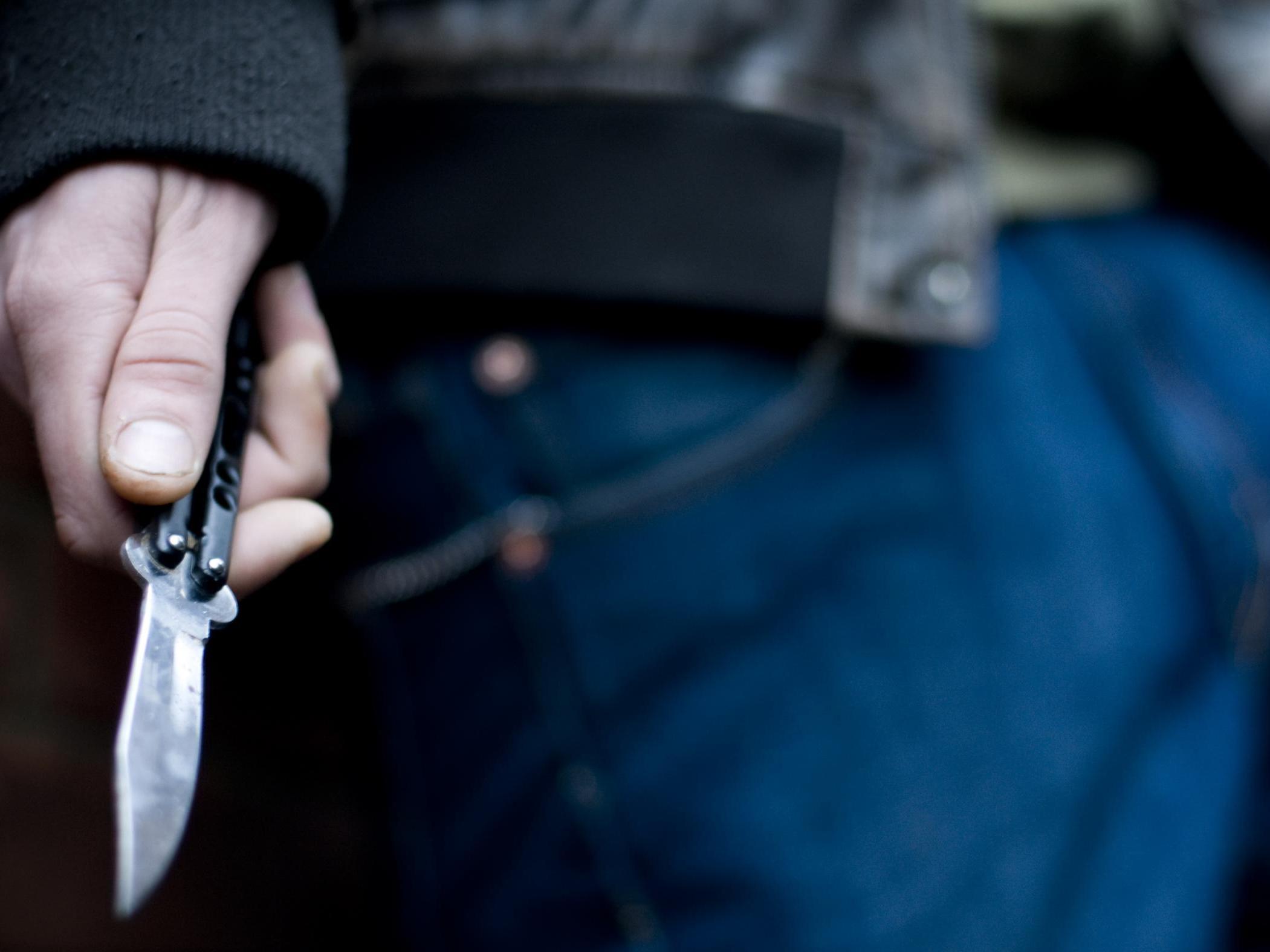 A youth brandishing a knife in the street