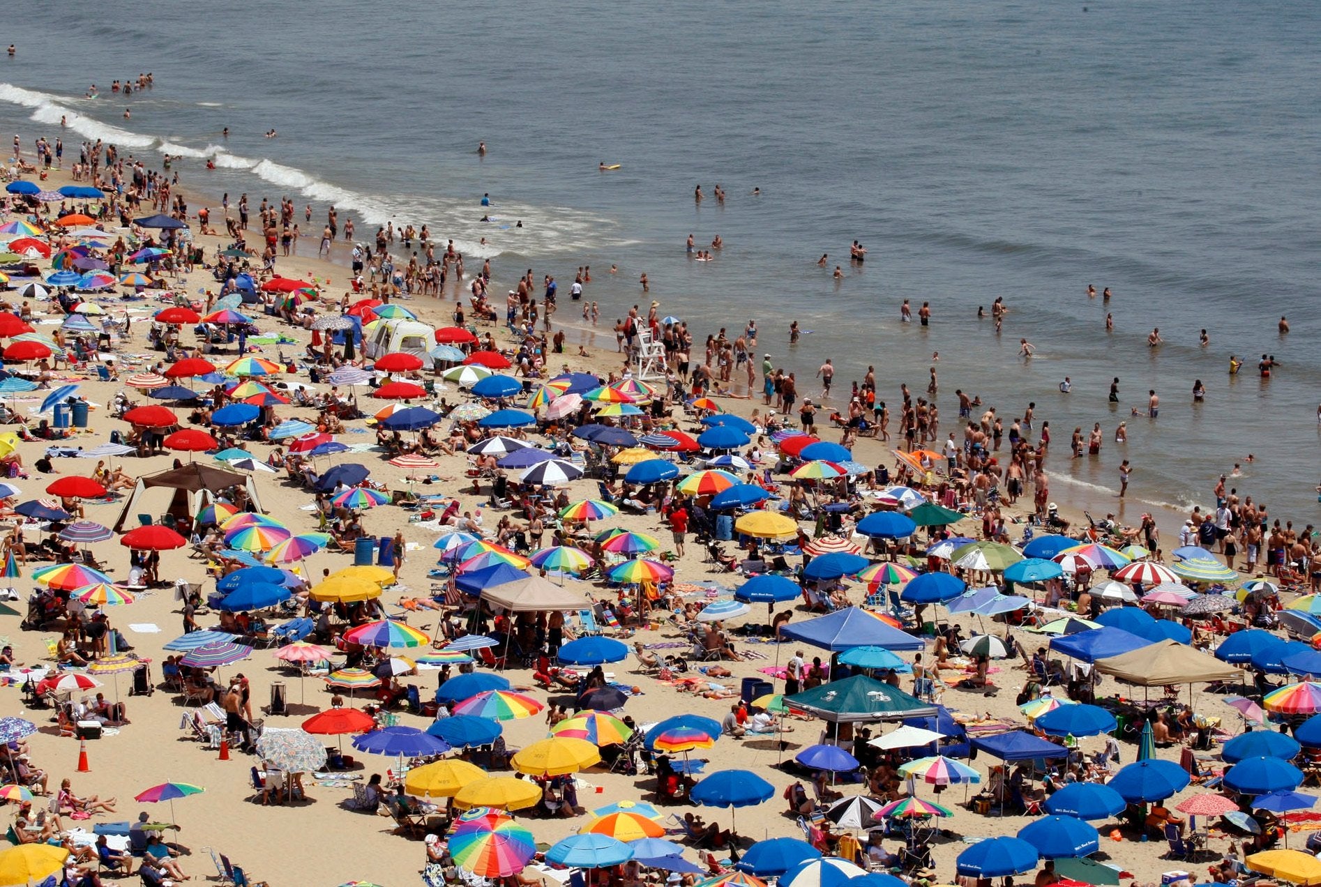 The beach umbrella had to be cut in half by emergency responders before it could be removed