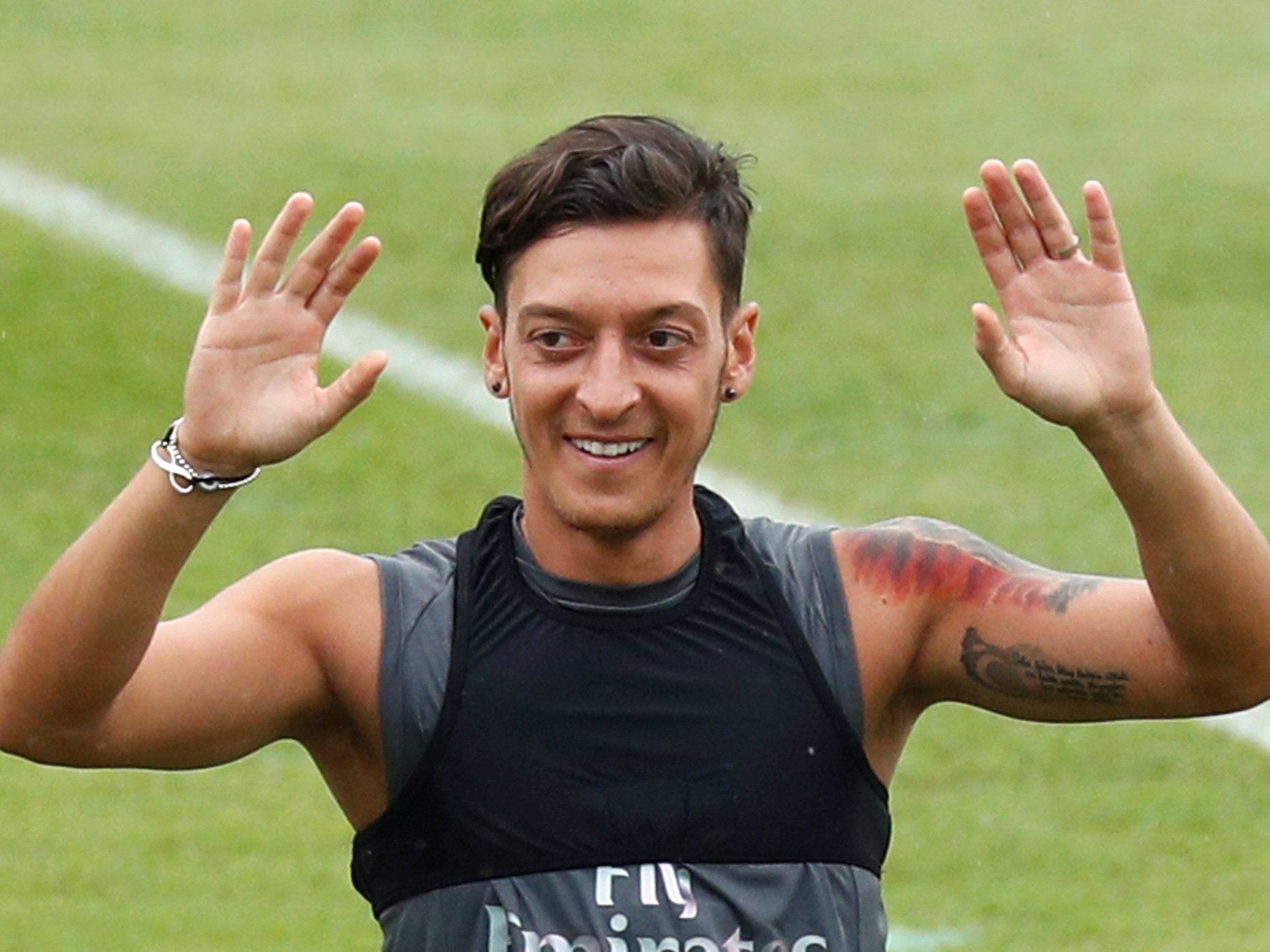 Ozil is with his Arsenal teammates in Singapore