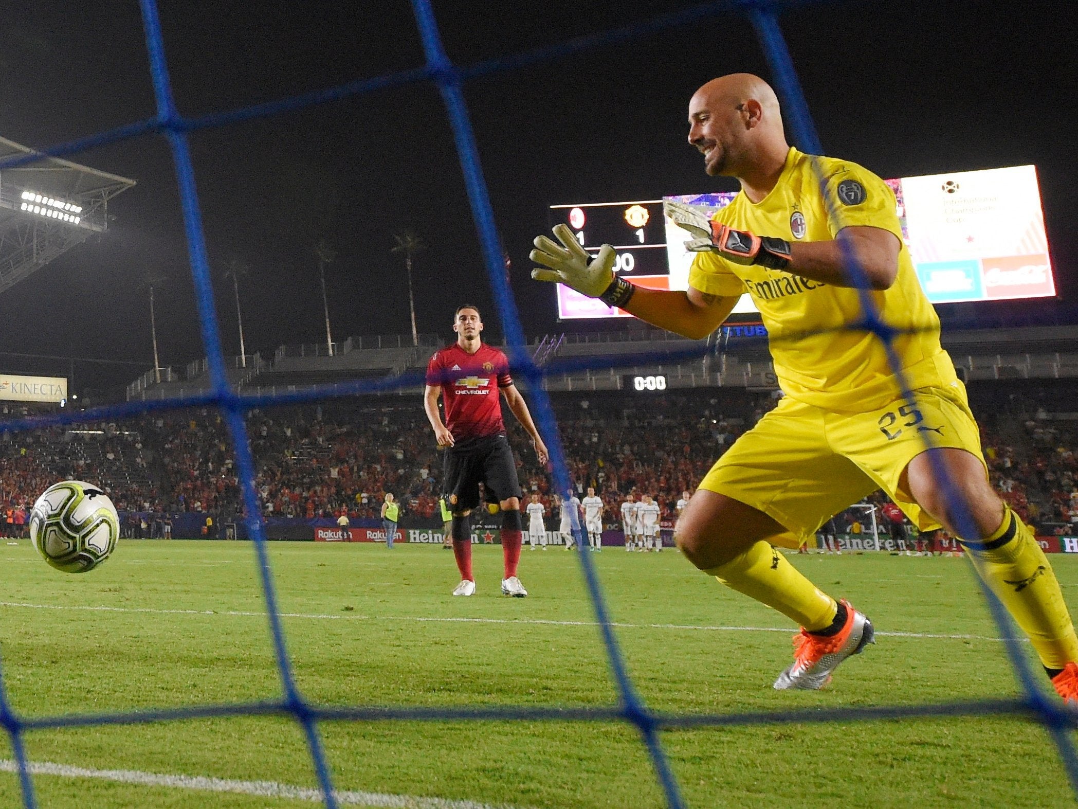 Matteo Darmian scores a penalty past AC Milan goalkeeper Pepe Reina