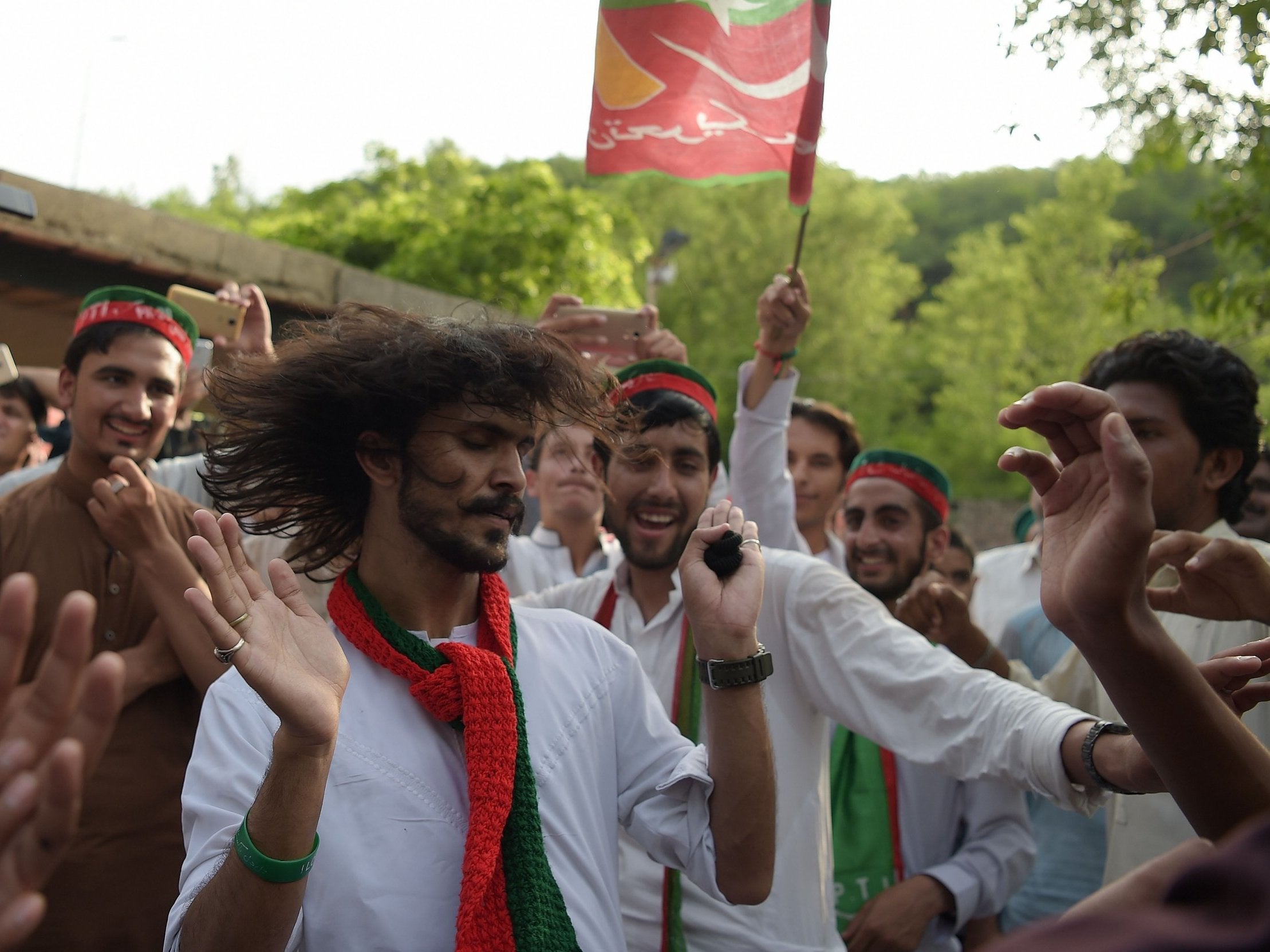 Supporters of Imran Khan celebrate near his residence in Islamabad on Thursday